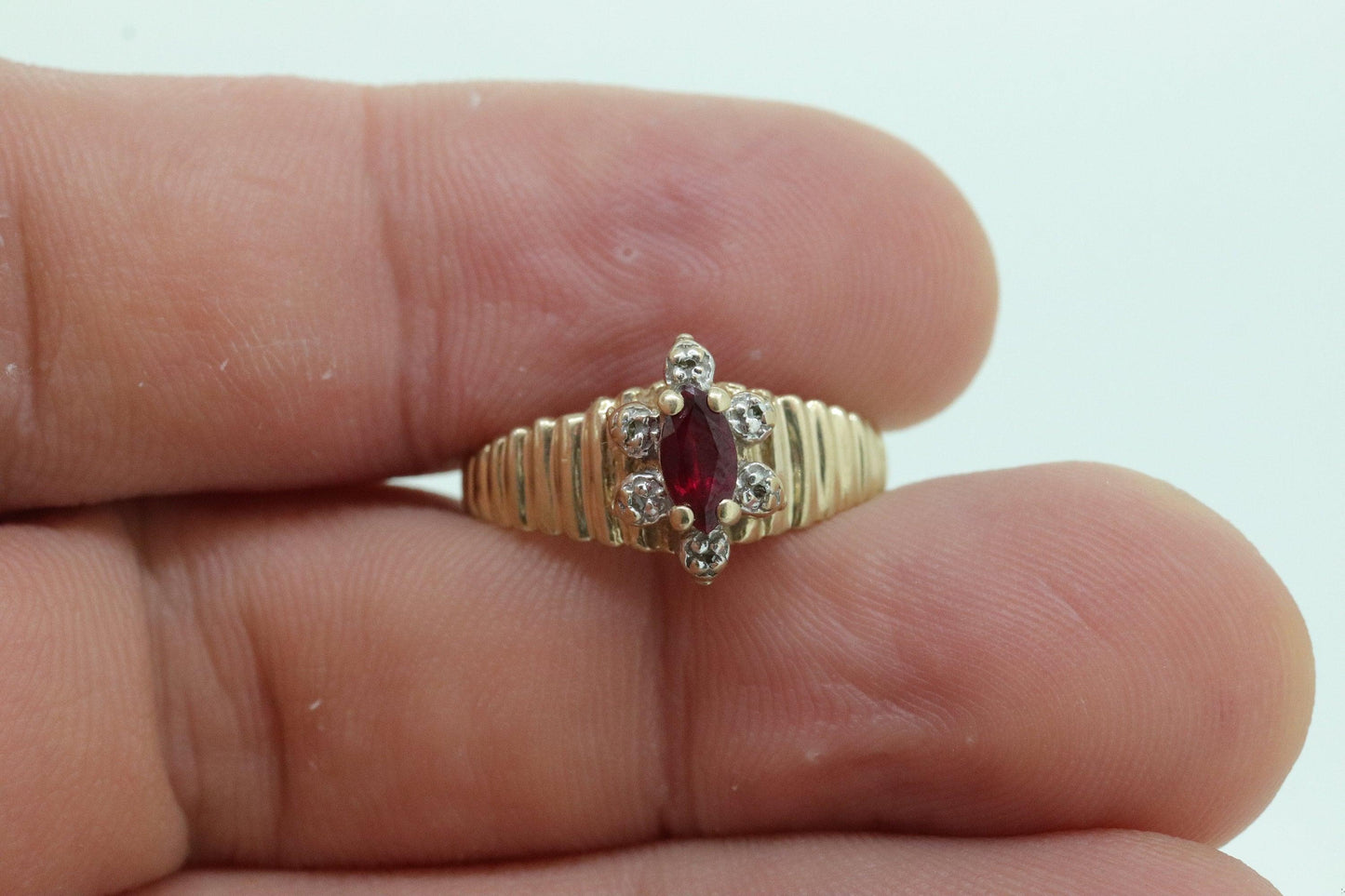 10k Ruby and Diamond HALO ring. 10k Yellow Gold Ribbed shank Ruby Halo ring.