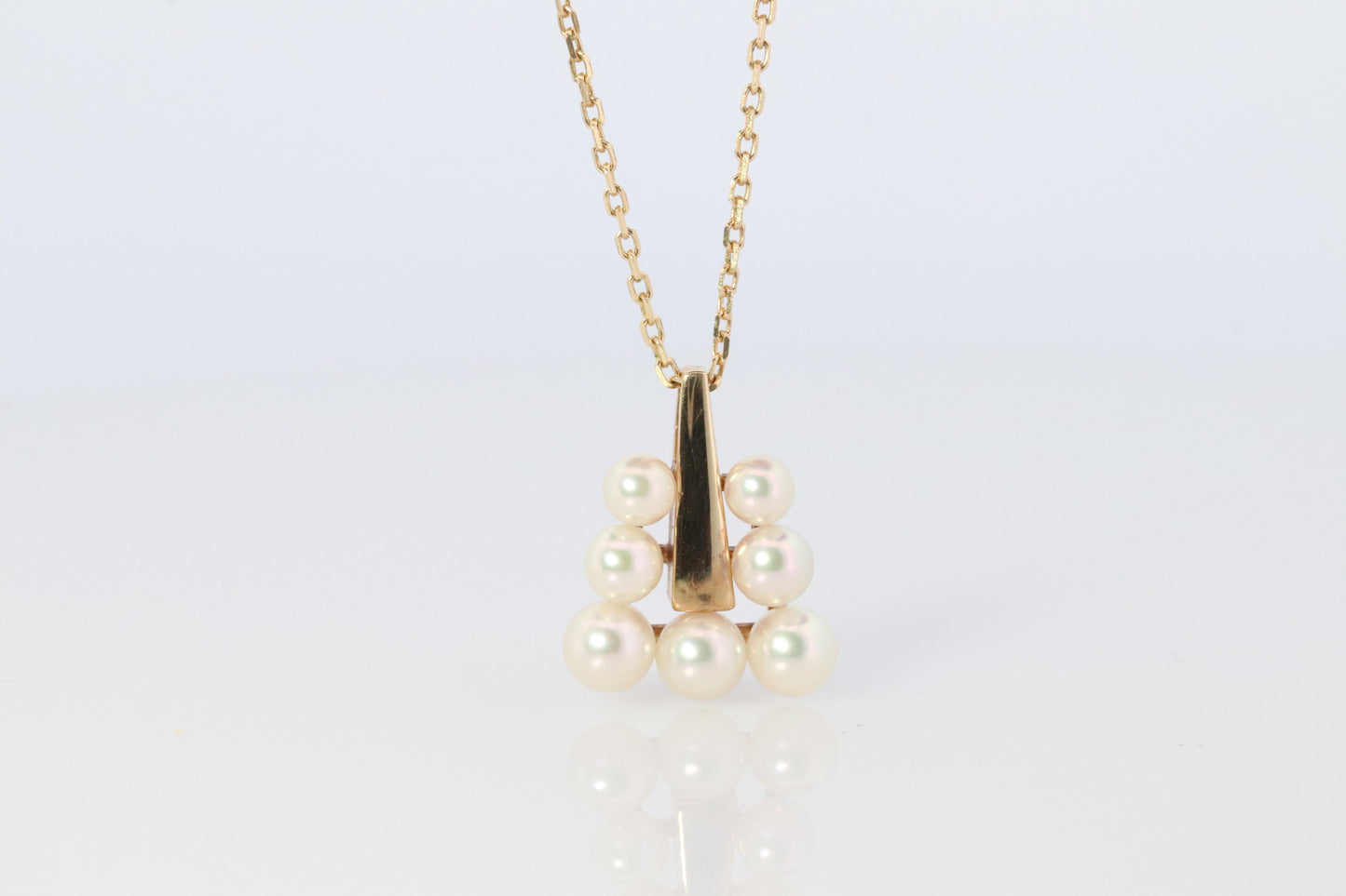 Mikimoto Pendant. 18k Gold Mikimoto Triangle Pyramid graduated Pearl Necklace.