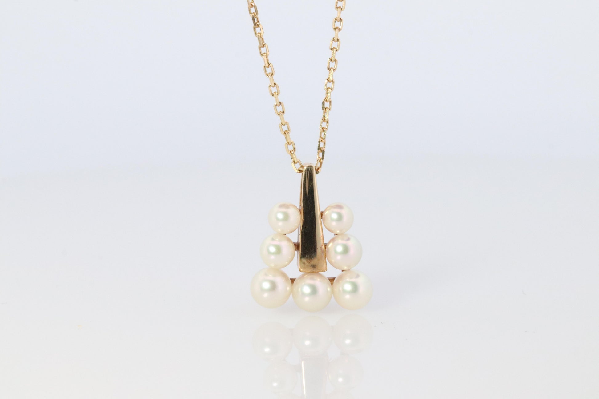 Mikimoto Pendant. 18k Gold Mikimoto Triangle Pyramid graduated Pearl Necklace.