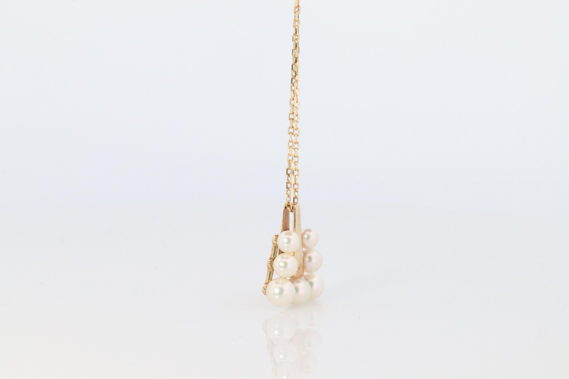 Mikimoto Pendant. 18k Gold Mikimoto Triangle Pyramid graduated Pearl Necklace.