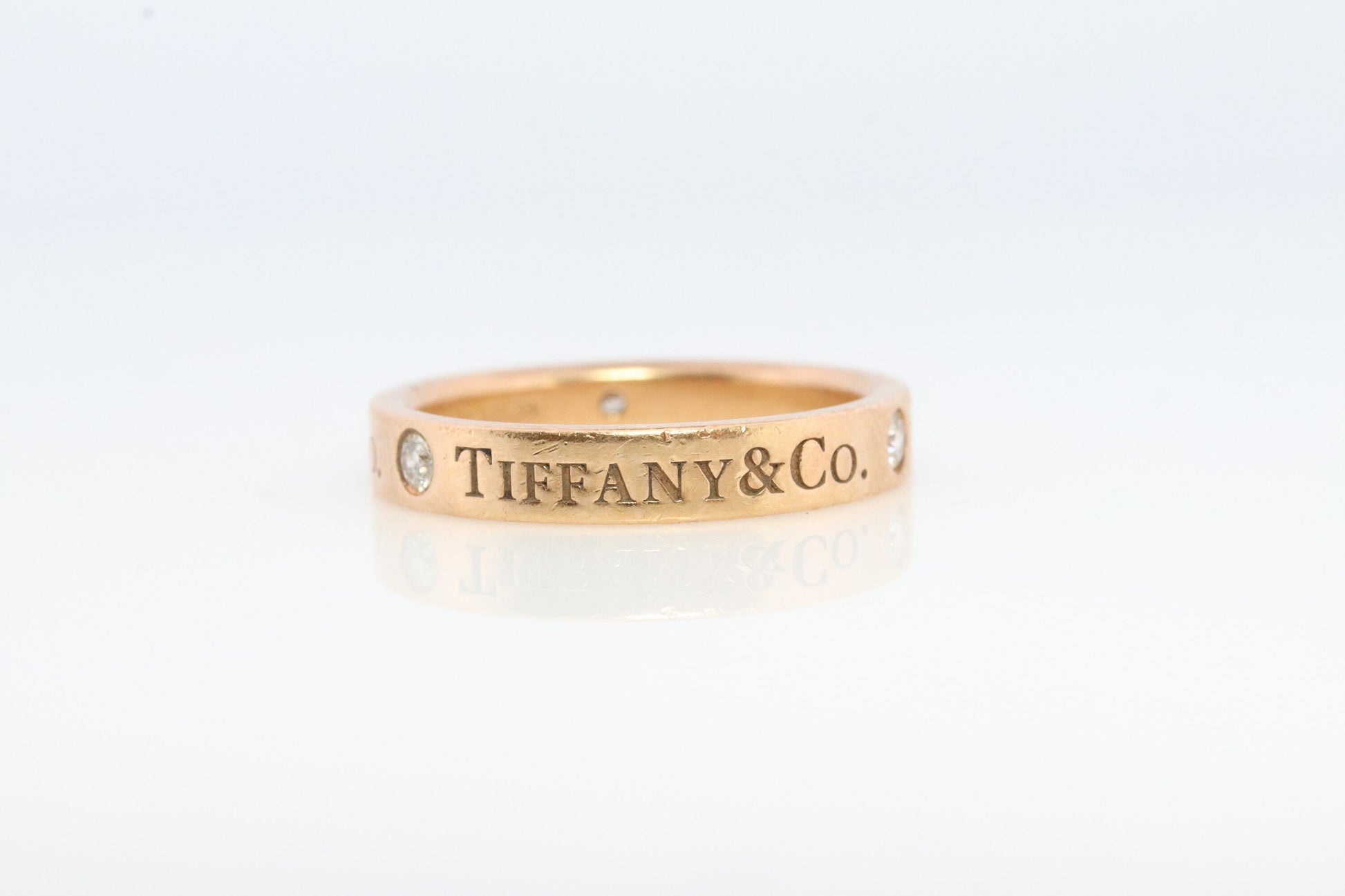 18k Tiffany and Co. band. 18k Tiffany Company Diamond wedding band. 18k Rose Gold Three diamond Bezel Vintage Tiffany & Co band.