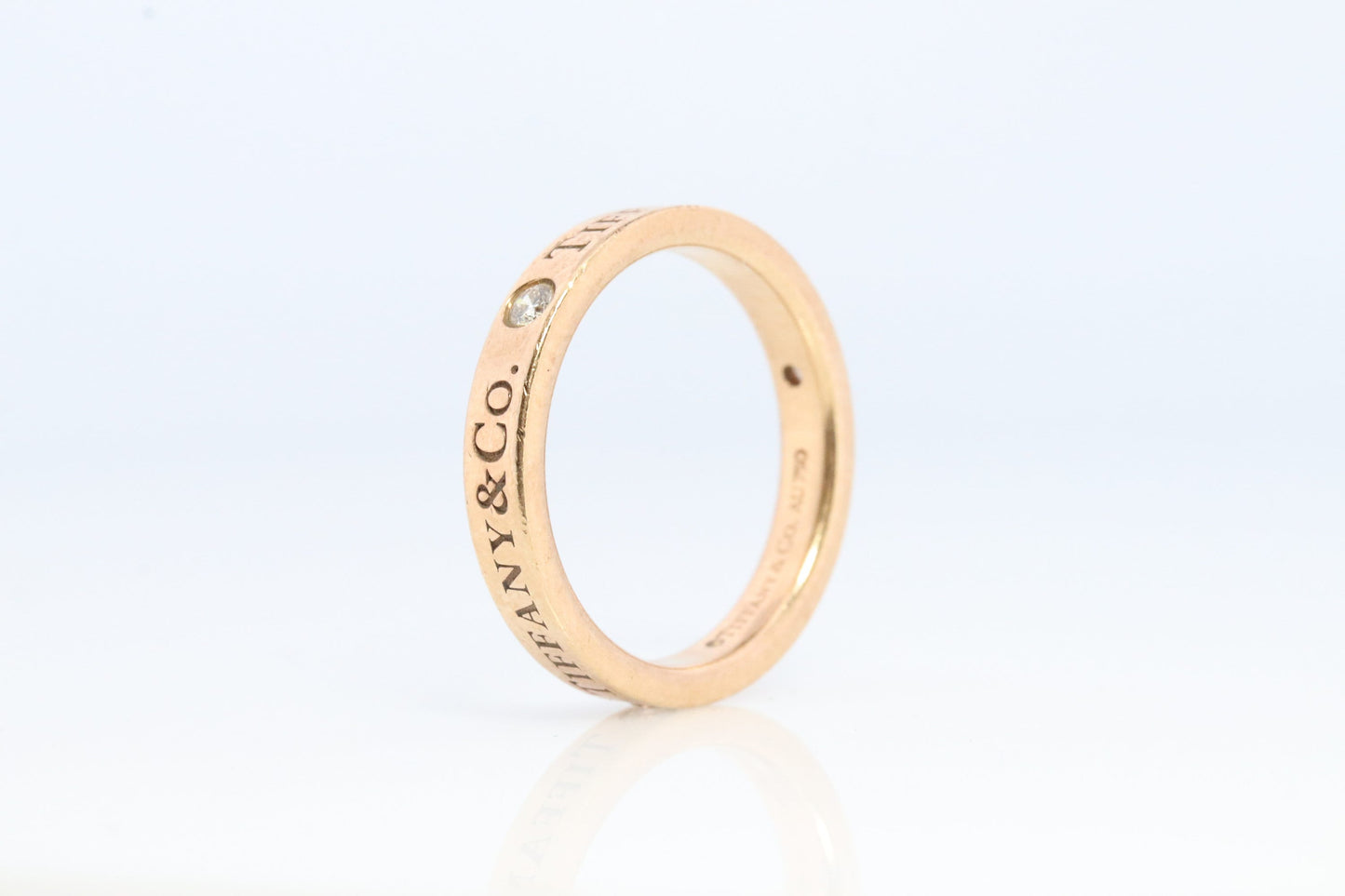 18k Tiffany and Co. band. 18k Tiffany Company Diamond wedding band. 18k Rose Gold Three diamond Bezel Vintage Tiffany & Co band.