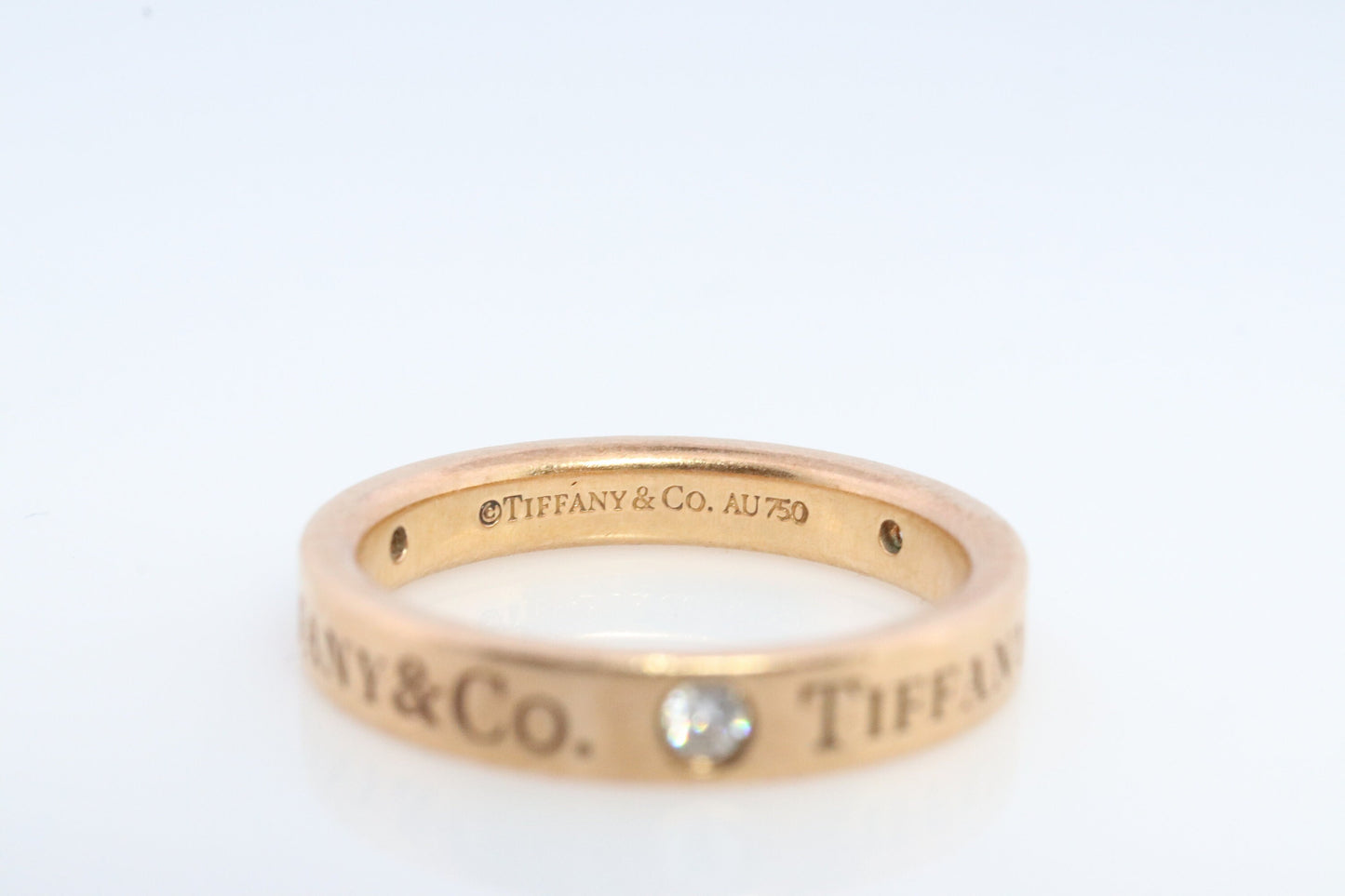 18k Tiffany and Co. band. 18k Tiffany Company Diamond wedding band. 18k Rose Gold Three diamond Bezel Vintage Tiffany & Co band.