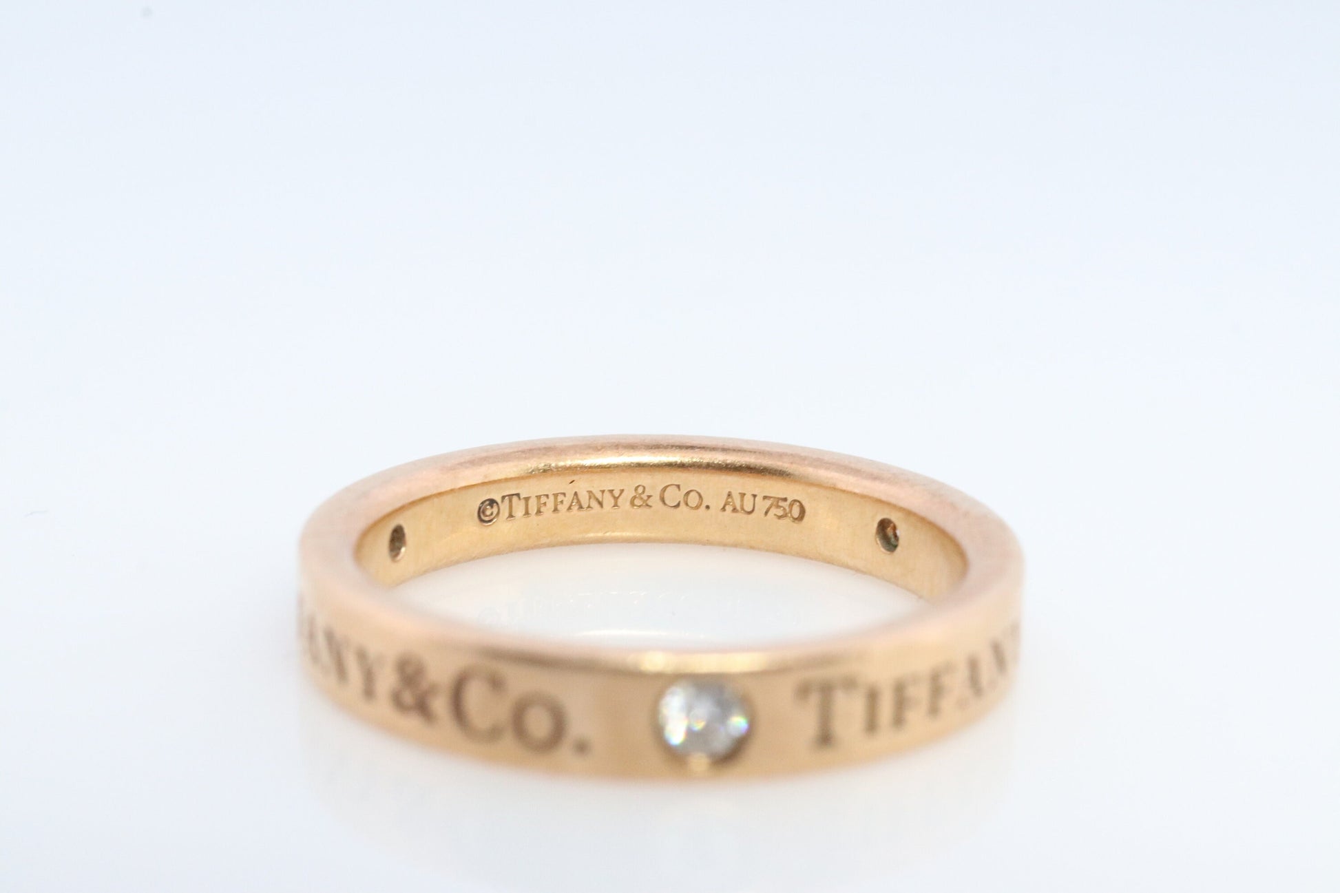 18k Tiffany and Co. band. 18k Tiffany Company Diamond wedding band. 18k Rose Gold Three diamond Bezel Vintage Tiffany & Co band.