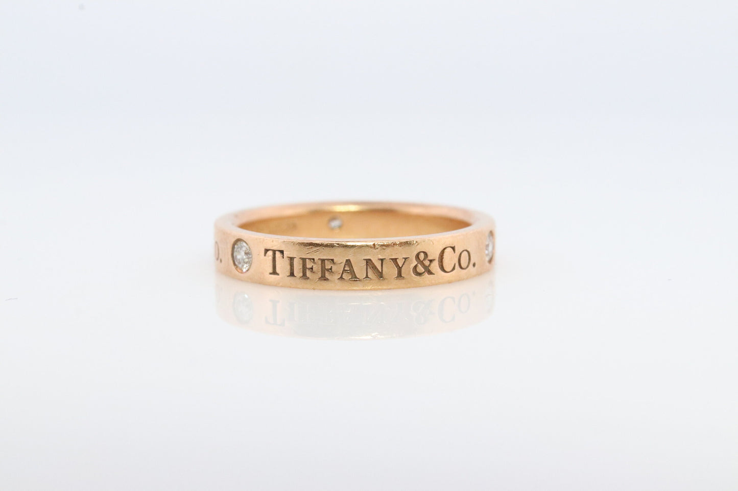 18k Tiffany and Co. band. 18k Tiffany Company Diamond wedding band. 18k Rose Gold Three diamond Bezel Vintage Tiffany & Co band.