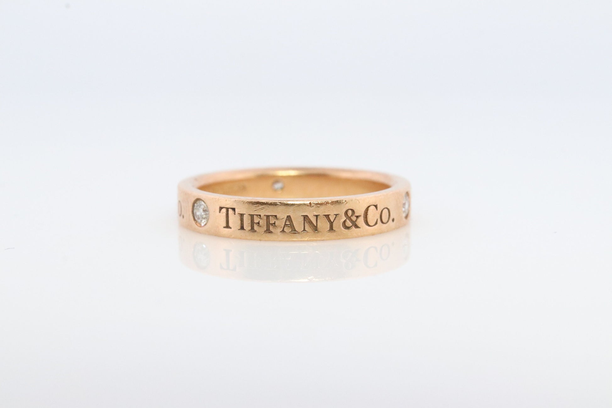 18k Tiffany and Co. band. 18k Tiffany Company Diamond wedding band. 18k Rose Gold Three diamond Bezel Vintage Tiffany & Co band.