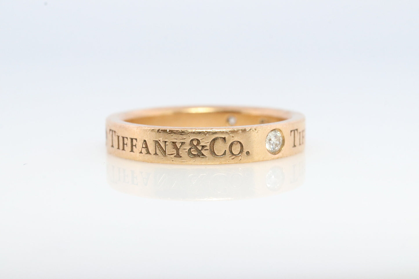 18k Tiffany and Co. band. 18k Tiffany Company Diamond wedding band. 18k Rose Gold Three diamond Bezel Vintage Tiffany & Co band.