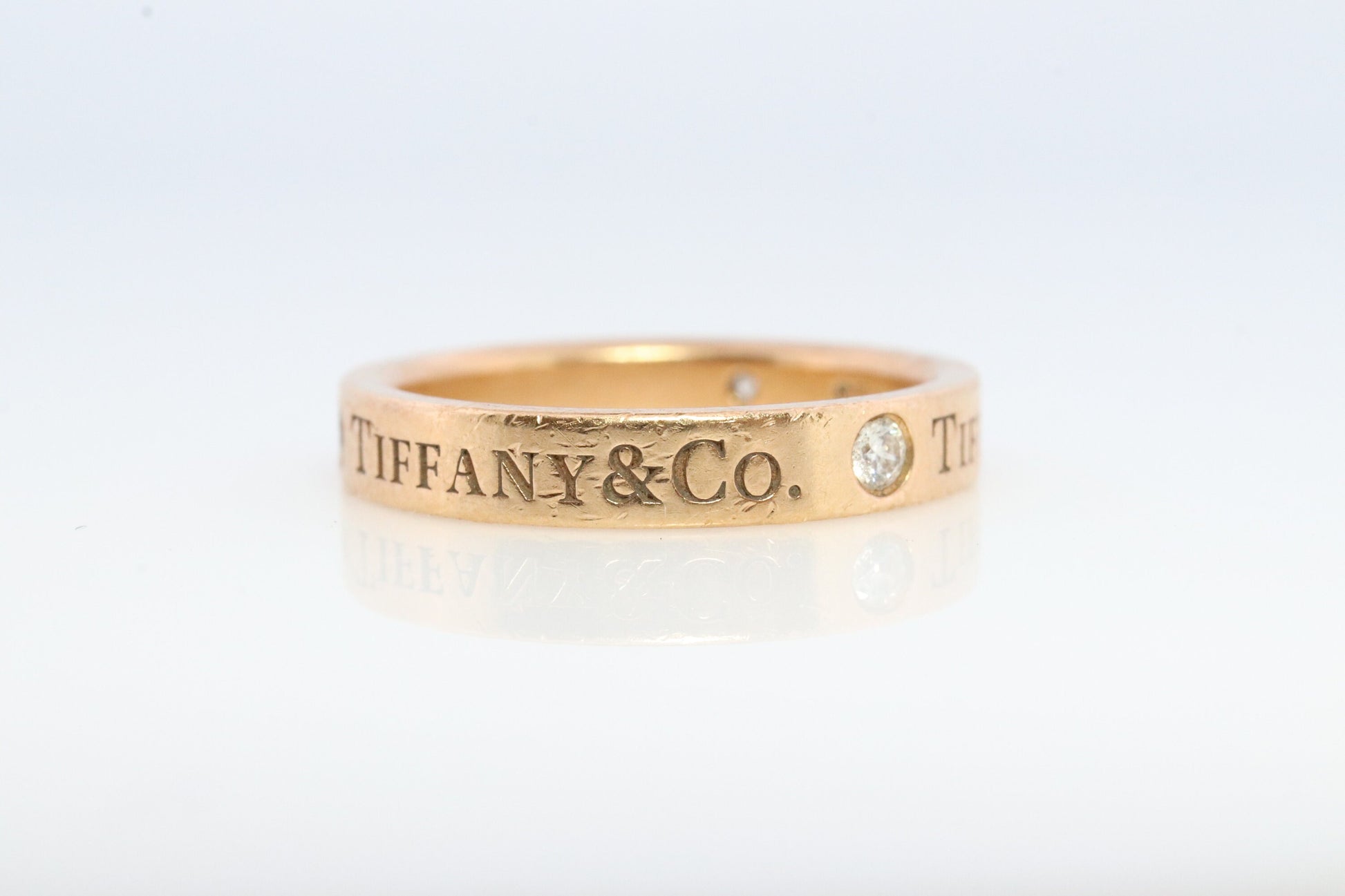 18k Tiffany and Co. band. 18k Tiffany Company Diamond wedding band. 18k Rose Gold Three diamond Bezel Vintage Tiffany & Co band.