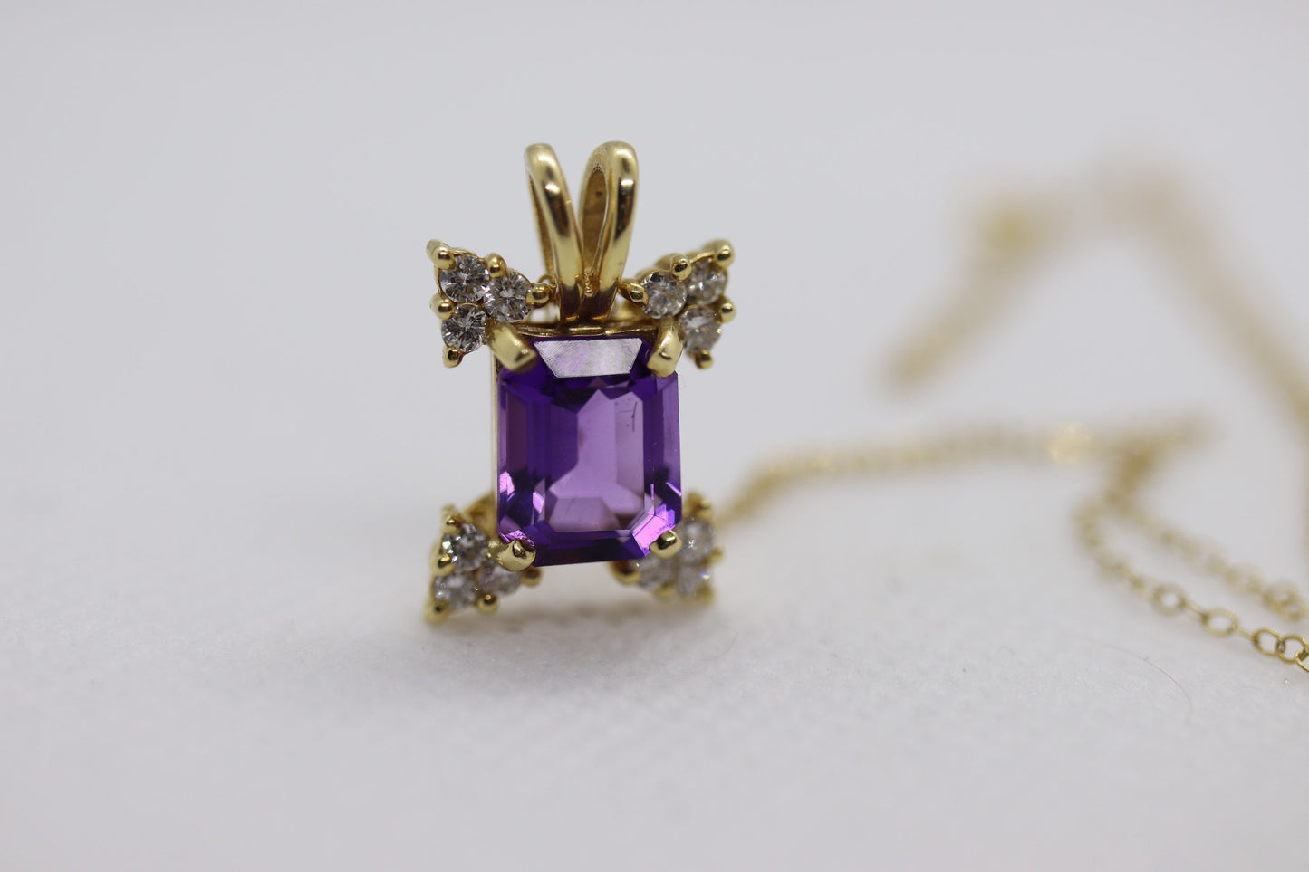 14k Amethyst emerald cut with Diamonds pendant. Diamond cluster star and 16in rolo necklace