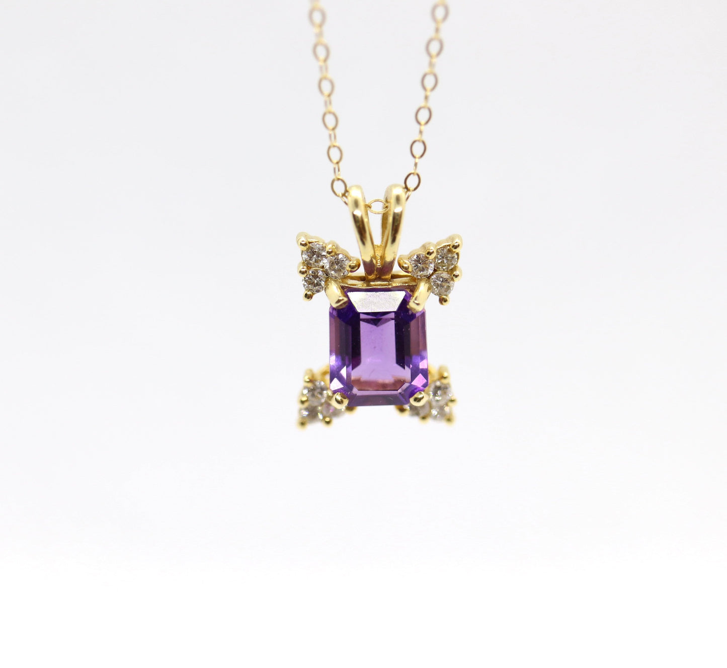 14k Amethyst emerald cut with Diamonds pendant. Diamond cluster star and 16in rolo necklace