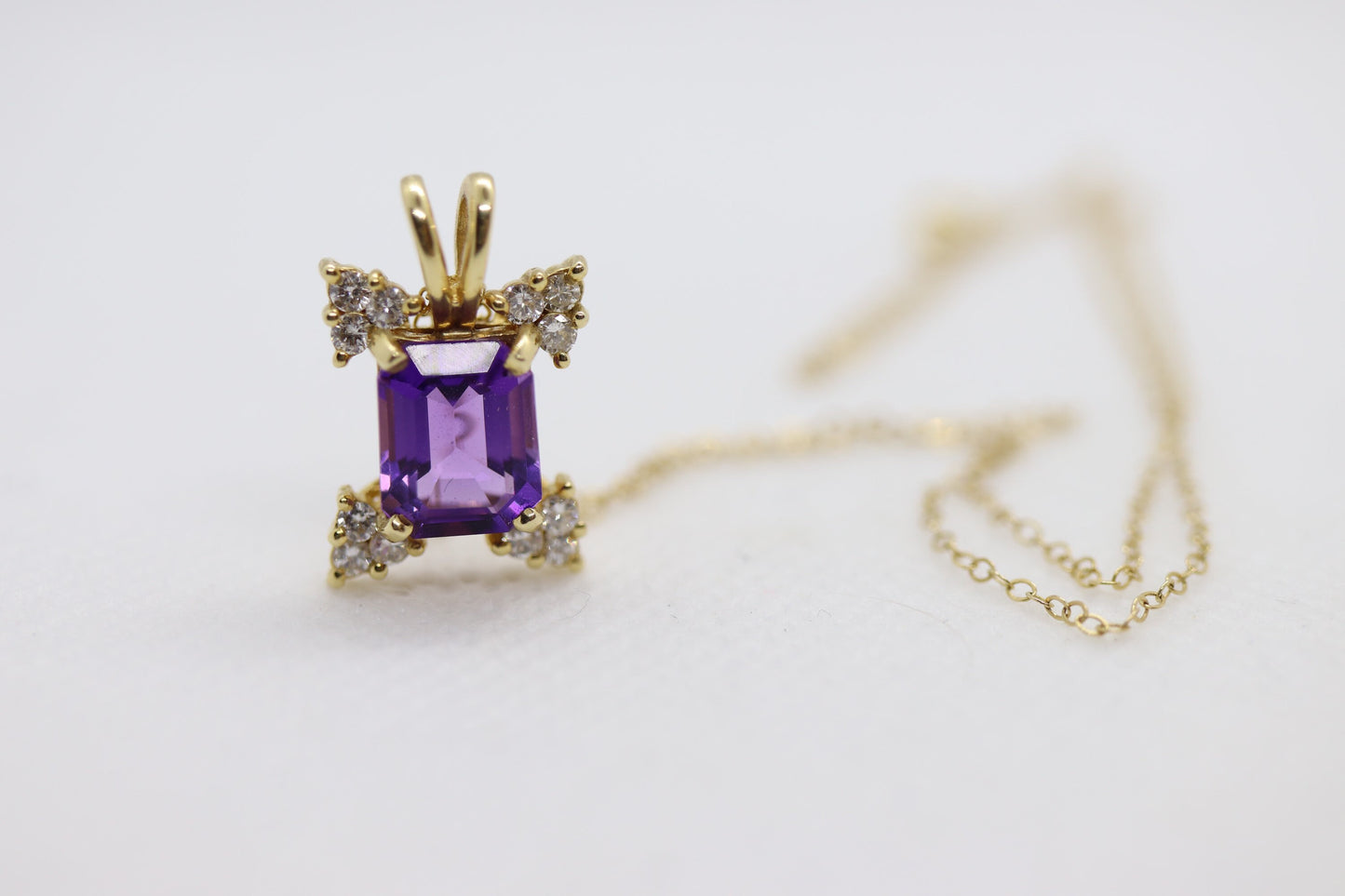 14k Amethyst emerald cut with Diamonds pendant. Diamond cluster star and 16in rolo necklace