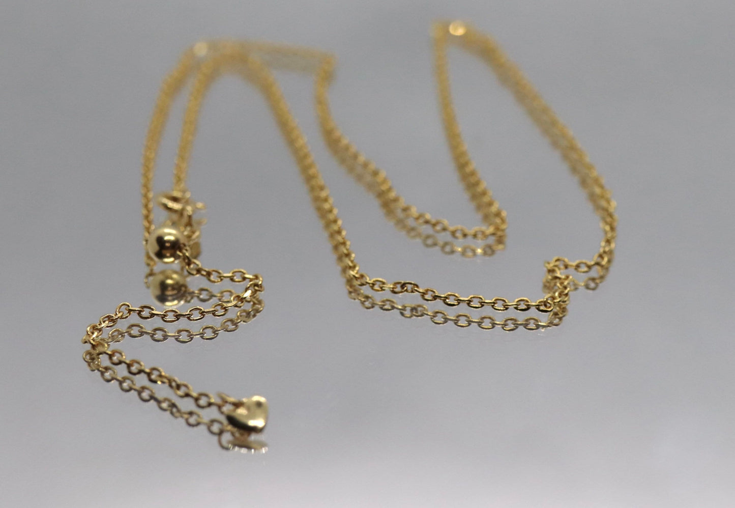 10k Adjustable Slide necklace. Beautiful heart charm with bead slider on oval rolo chain. 23.5in