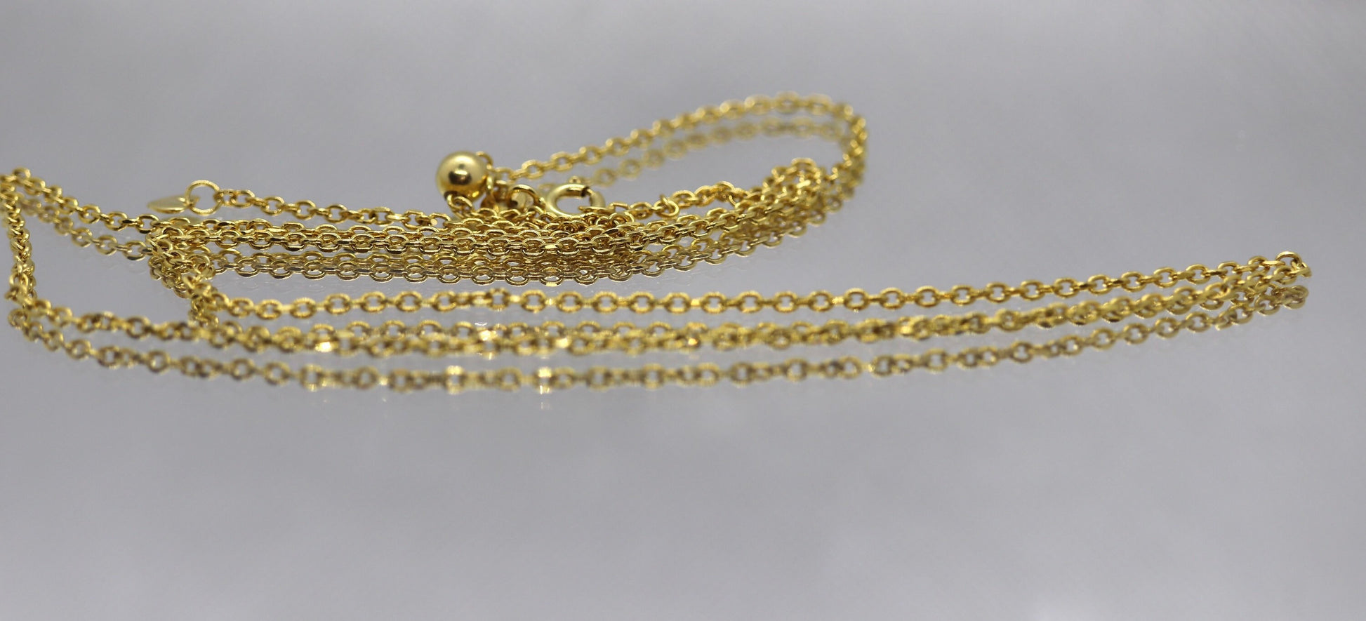 10k Adjustable Slide necklace. Beautiful heart charm with bead slider on oval rolo chain. 23.5in
