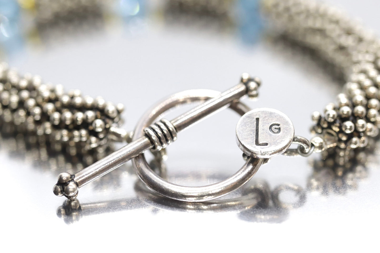 Laura Gibson Bracelet. Sterling Silver and 18k Beads with Dangling Faceted Gems - Topaz - (584)