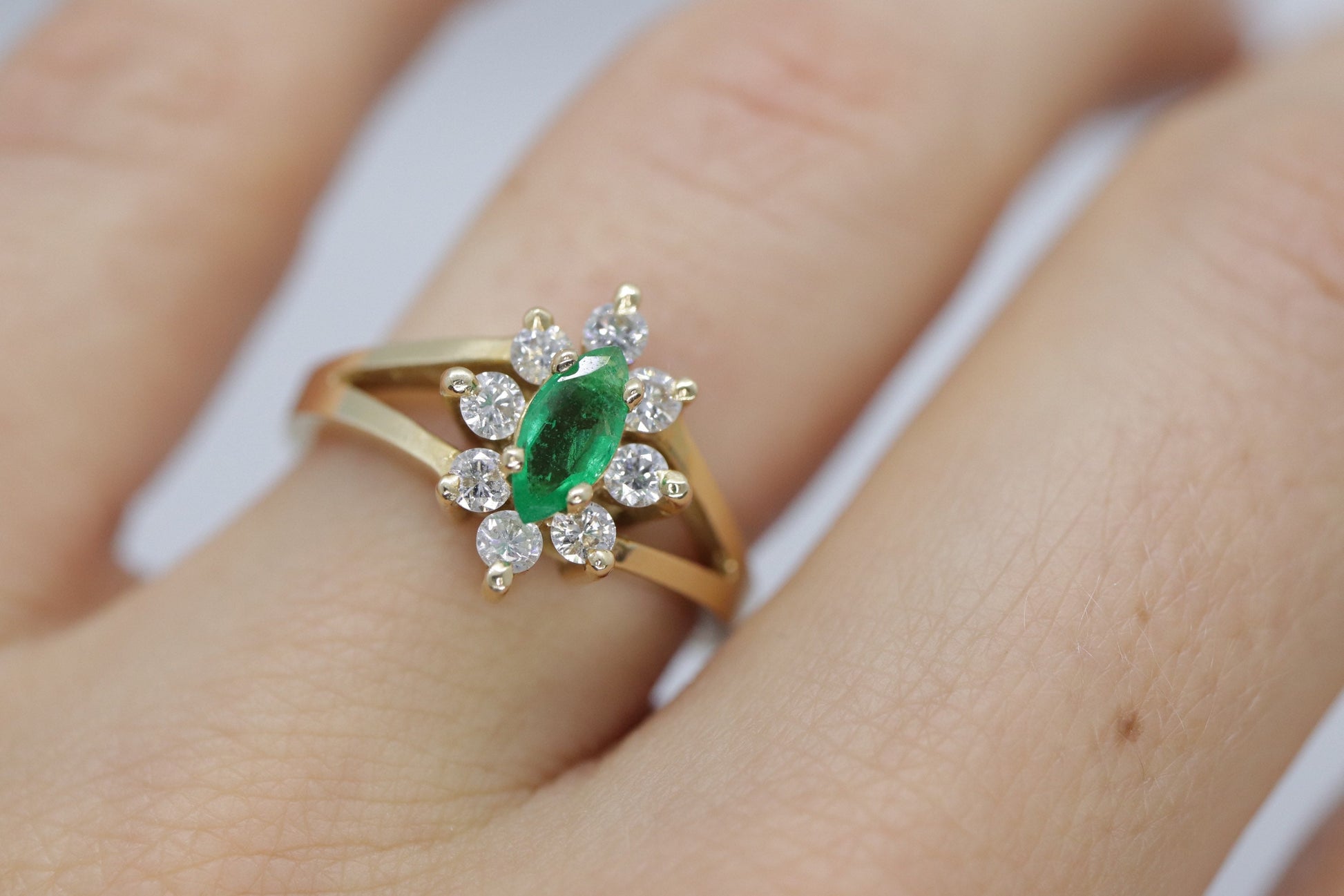 14k Marquise Emerald and Diamond Halo yellow gold ring. 0.36ctw in diamonds
