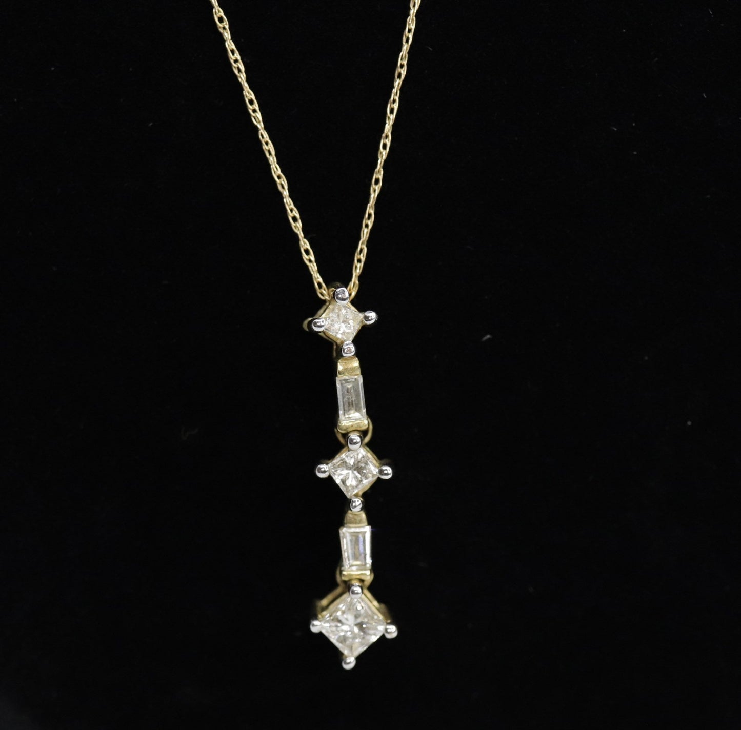 10k 3 Diamond Past Present Future Journey Pendant. 0.60ctw Princess and Baguette diamonds. 10k Yellow gold Rope necklace. (88)