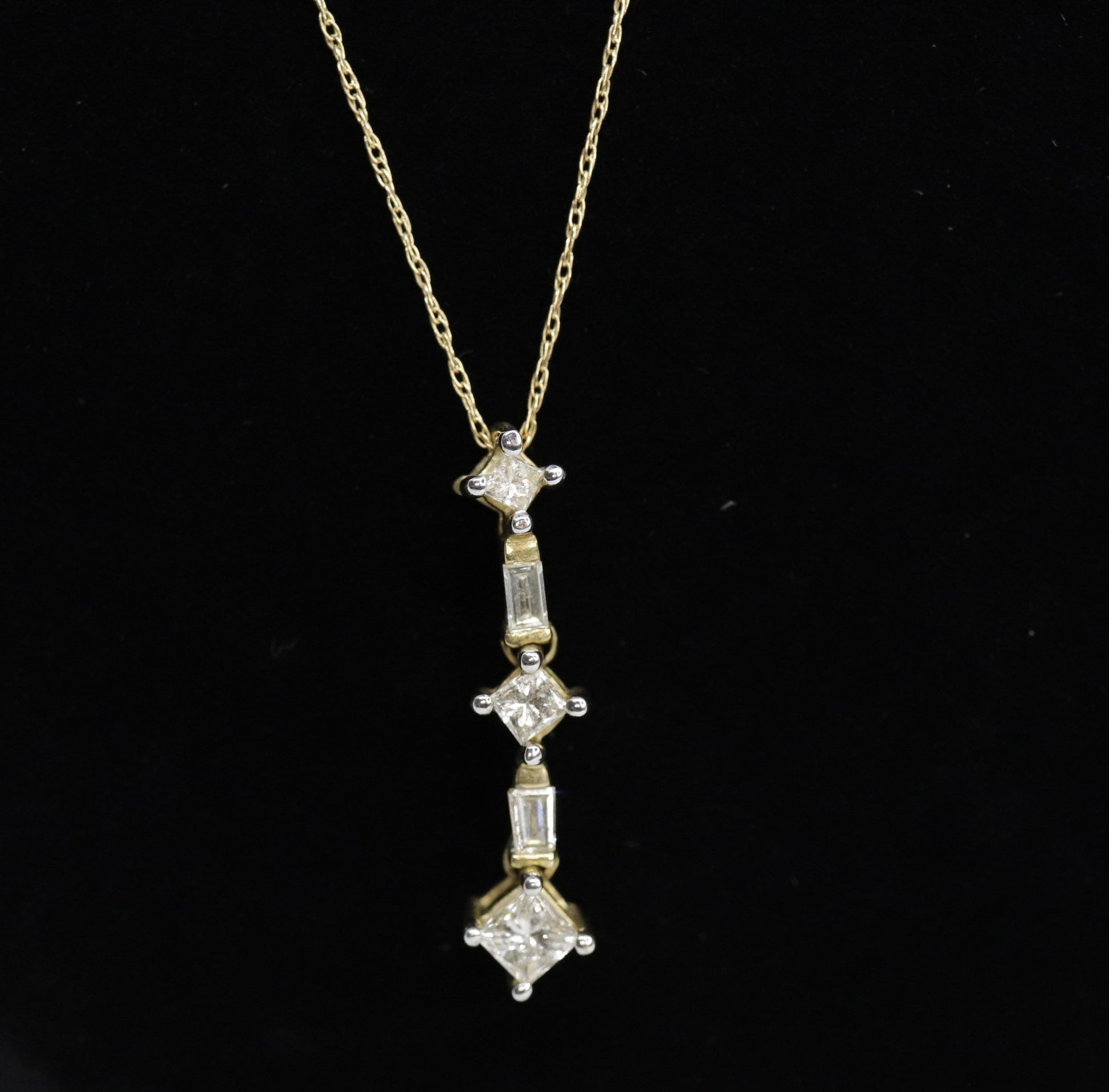 10k 3 Diamond Past Present Future Journey Pendant. 0.60ctw Princess and Baguette diamonds. 10k Yellow gold Rope necklace. (88)