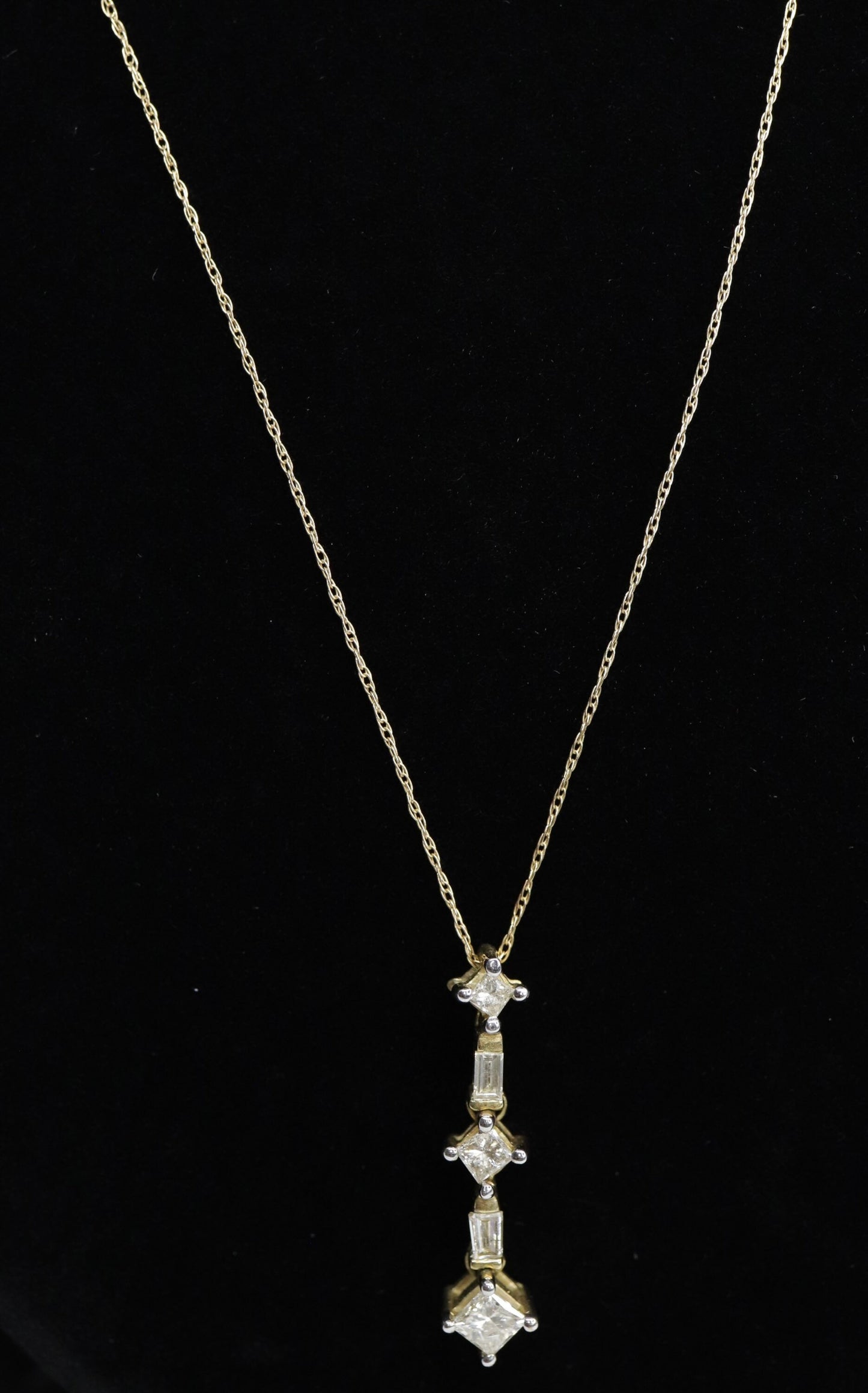 10k 3 Diamond Past Present Future Journey Pendant. 0.60ctw Princess and Baguette diamonds. 10k Yellow gold Rope necklace. (88)