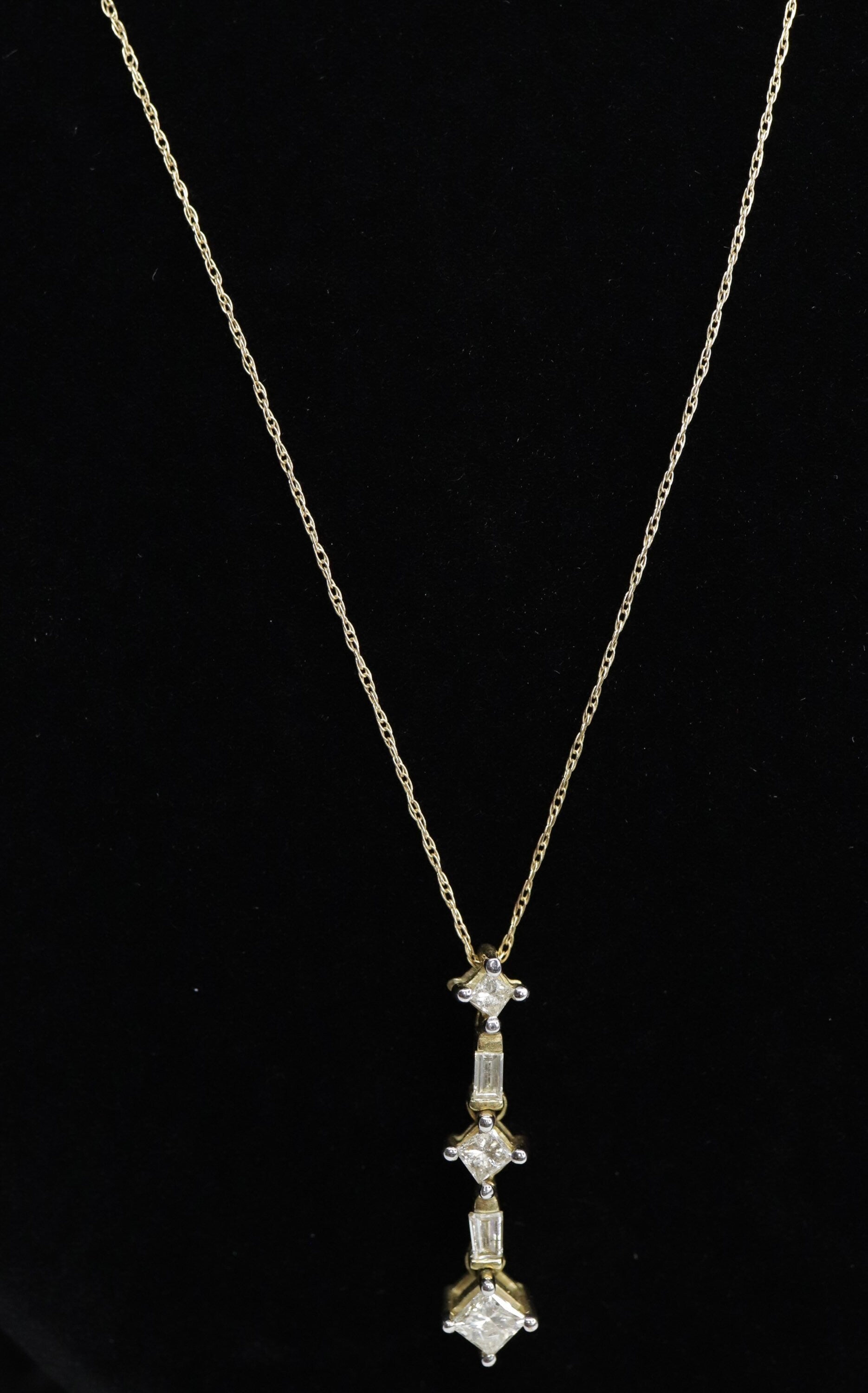 10k 3 Diamond Past Present Future Journey Pendant. 0.60ctw Princess and Baguette diamonds. 10k Yellow gold Rope necklace. (88)