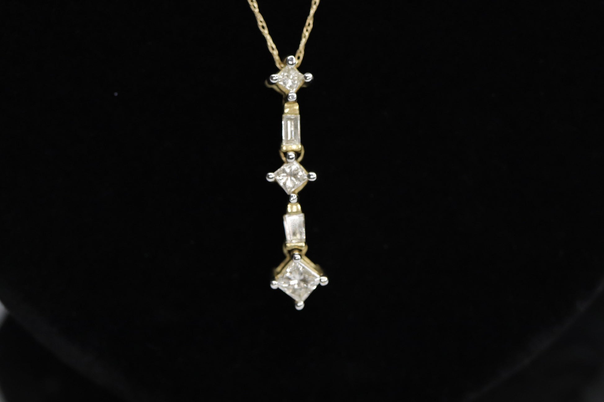 10k 3 Diamond Past Present Future Journey Pendant. 0.60ctw Princess and Baguette diamonds. 10k Yellow gold Rope necklace. (88)