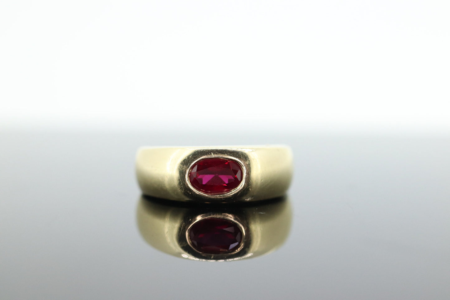 14k Ruby Ring. Bezel set Ruby ring. 14k yellow gold and oval Ruby bezel set. Wide ruby band. st(106)