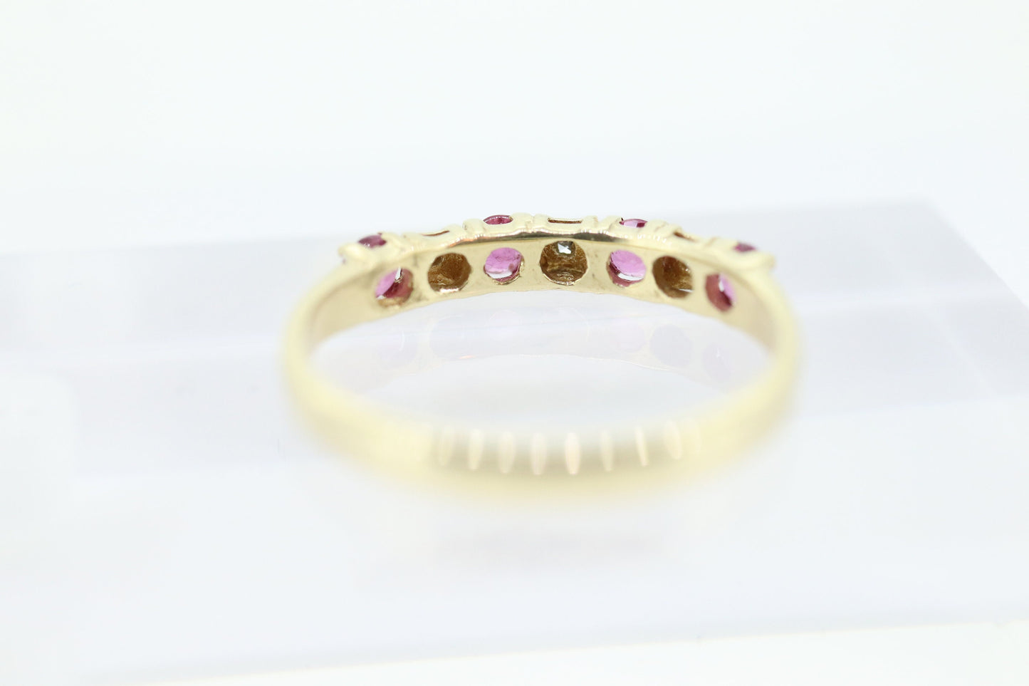 10k Anniversary Ruby Ring. A 10k gold ring with round Ruby and diamond accents eternity band. st(72)