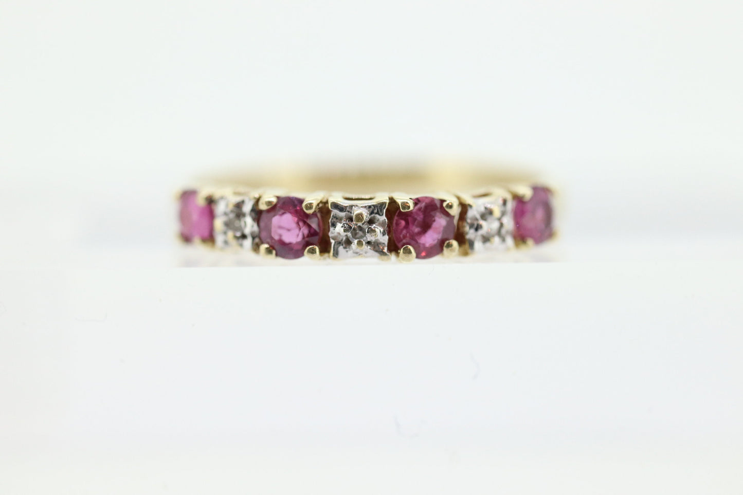 10k Anniversary Ruby Ring. A 10k gold ring with round Ruby and diamond accents eternity band. st(72)
