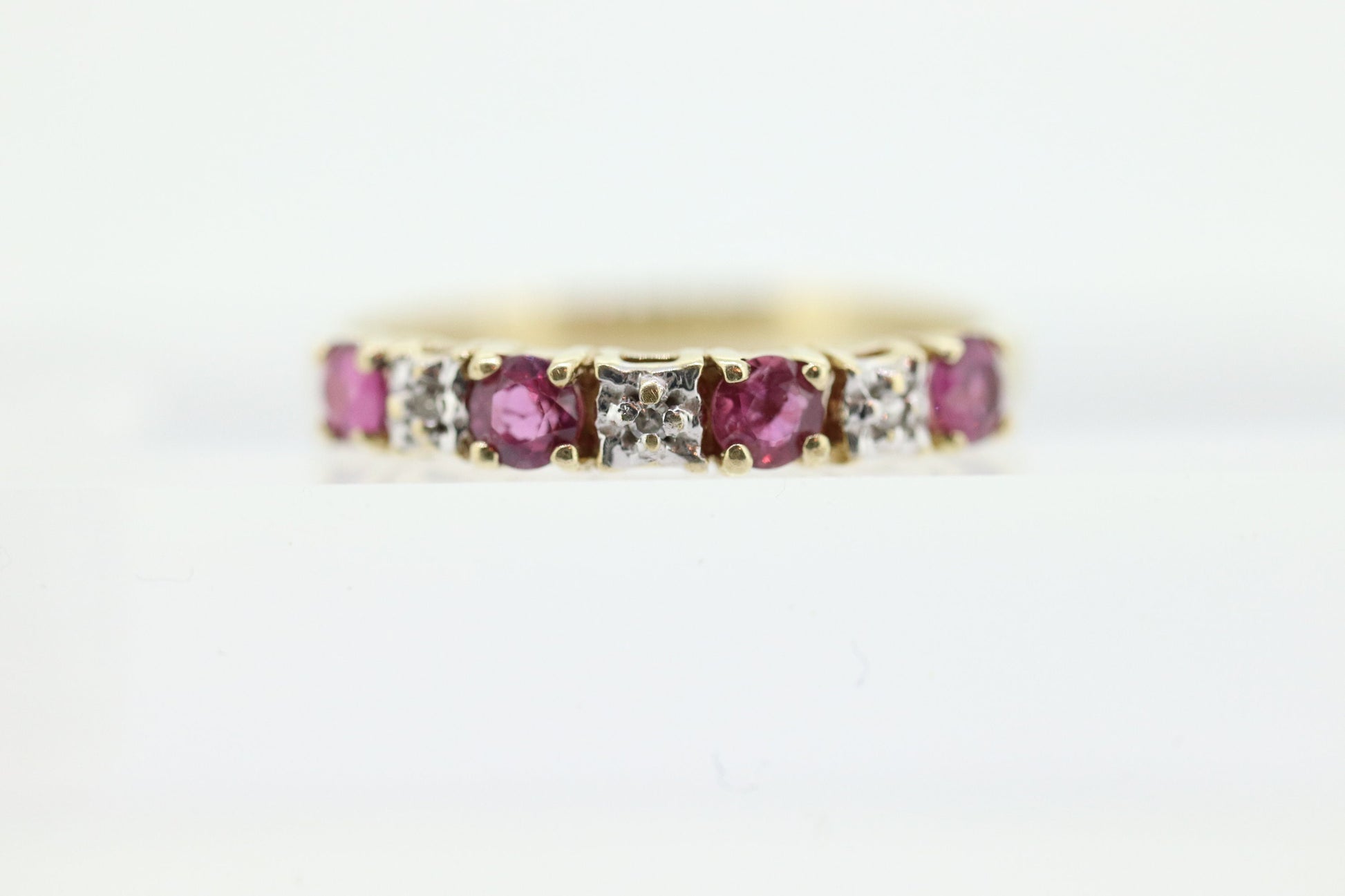 10k Anniversary Ruby Ring. A 10k gold ring with round Ruby and diamond accents eternity band. st(72)
