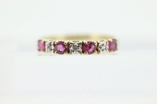 10k Anniversary Ruby Ring. A 10k gold ring with round Ruby and diamond accents eternity band. st(72)