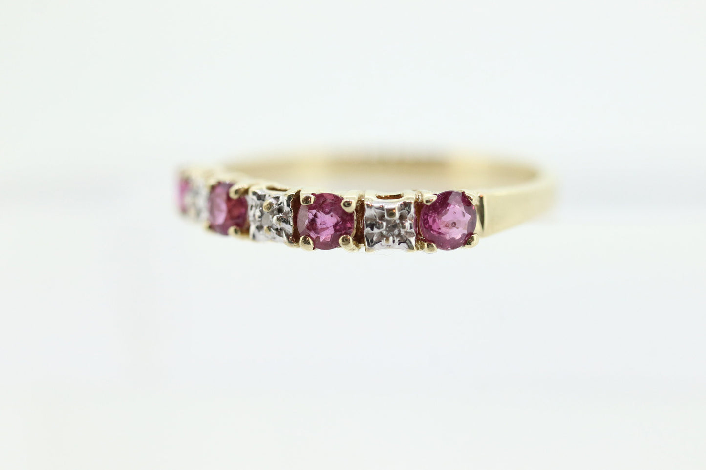 10k Anniversary Ruby Ring. A 10k gold ring with round Ruby and diamond accents eternity band. st(72)