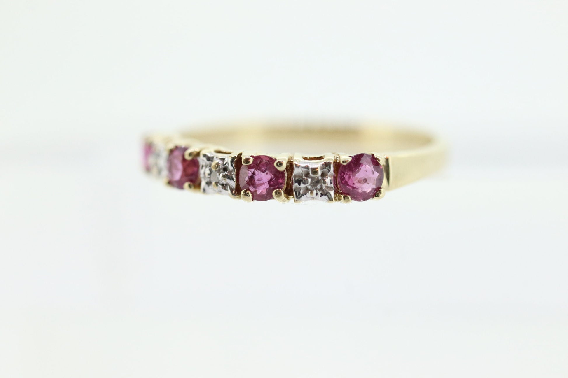 10k Anniversary Ruby Ring. A 10k gold ring with round Ruby and diamond accents eternity band. st(72)
