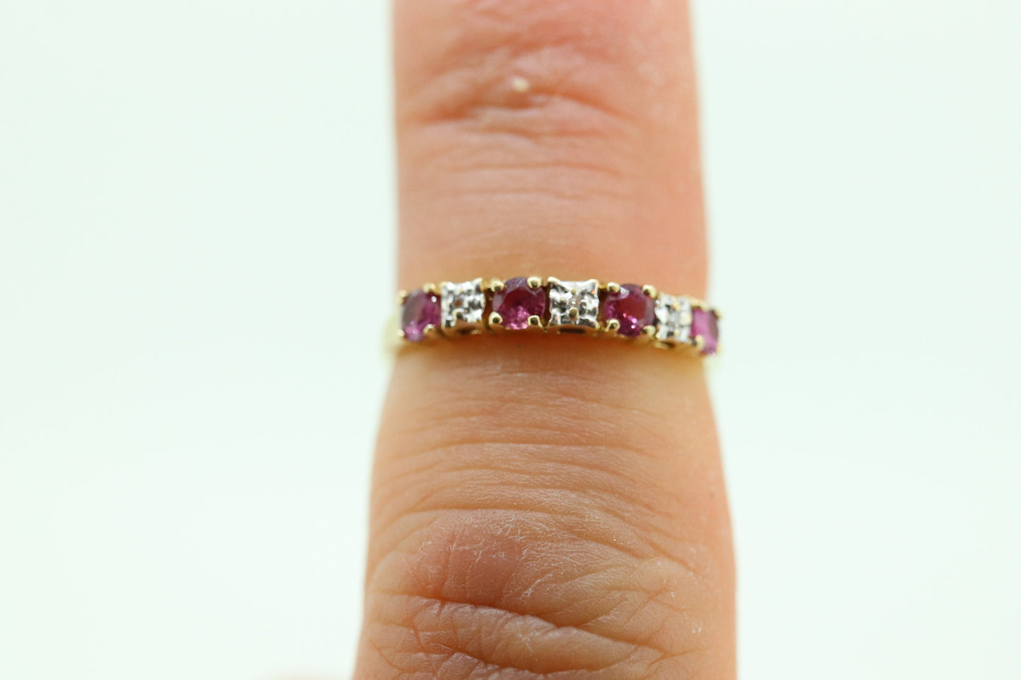 10k Anniversary Ruby Ring. A 10k gold ring with round Ruby and diamond accents eternity band. st(72)