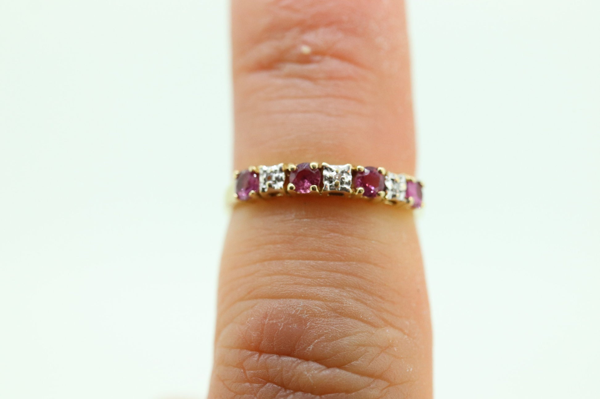 10k Anniversary Ruby Ring. A 10k gold ring with round Ruby and diamond accents eternity band. st(72)