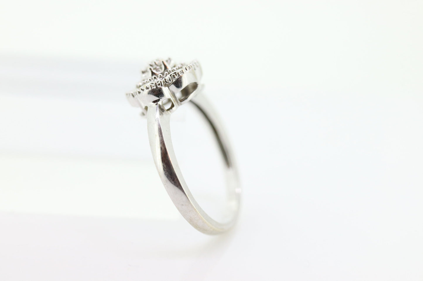 Diamond Daisy Cluster Elevated Ring. 10k White gold with round baguette diamond flower arrangement. st(52/90)