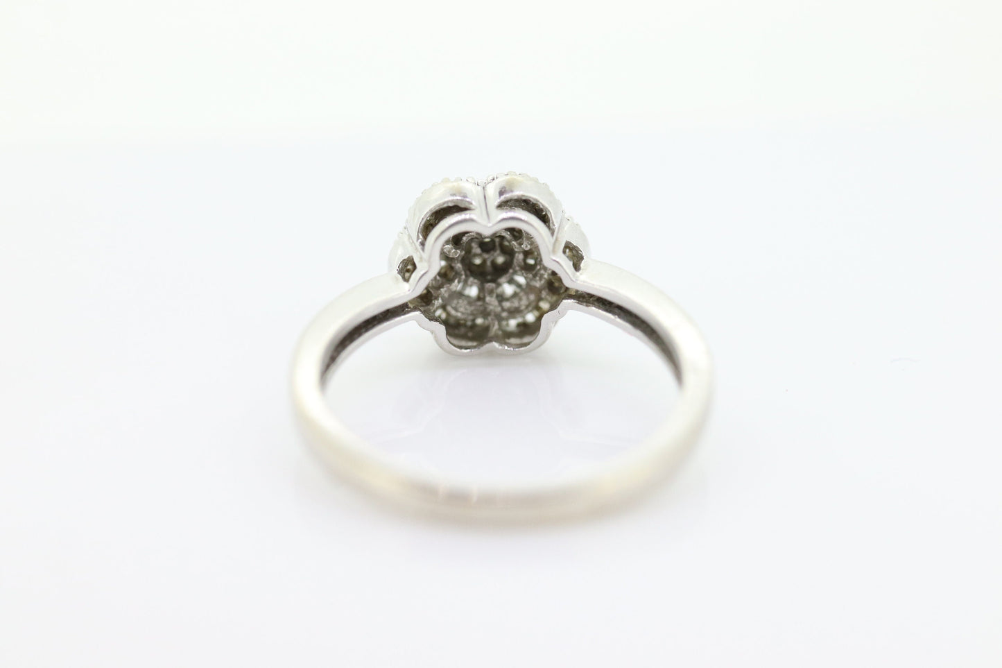 Diamond Daisy Cluster Elevated Ring. 10k White gold with round baguette diamond flower arrangement. st(52/90)