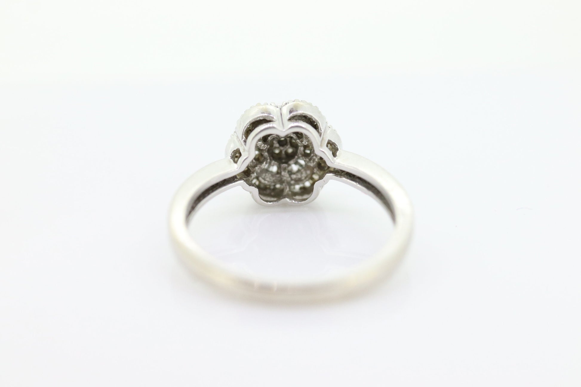 Diamond Daisy Cluster Elevated Ring. 10k White gold with round baguette diamond flower arrangement. st(52/90)