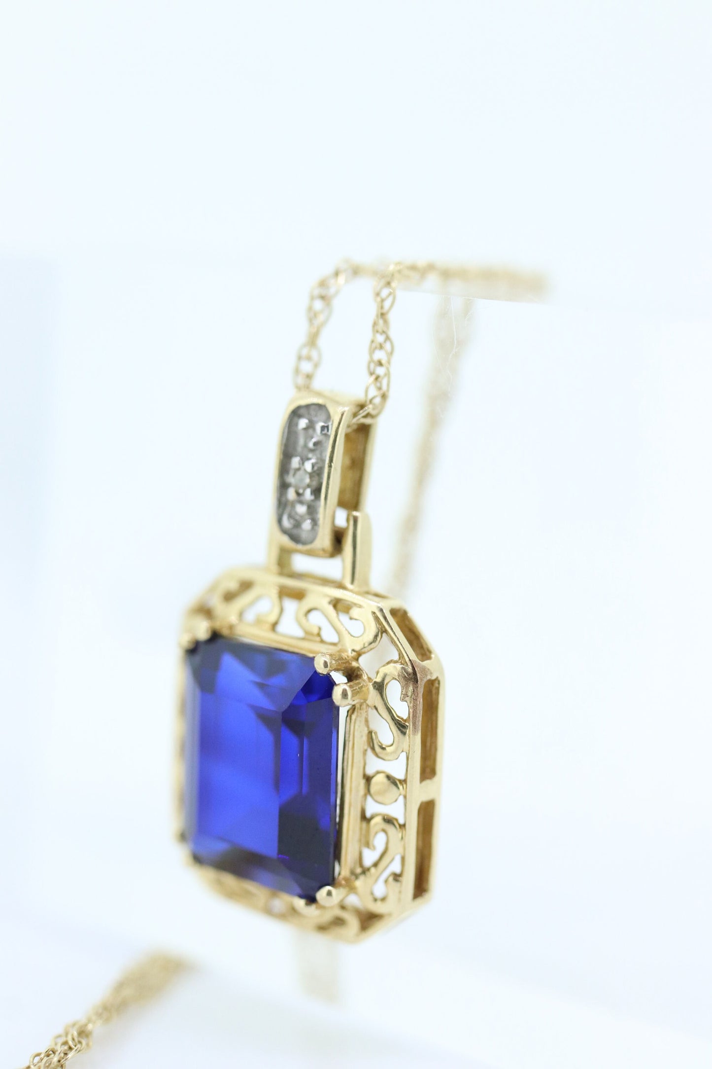 Blue emerald Sapphire and diamond 10k pendant. 10k twisted rope necklace