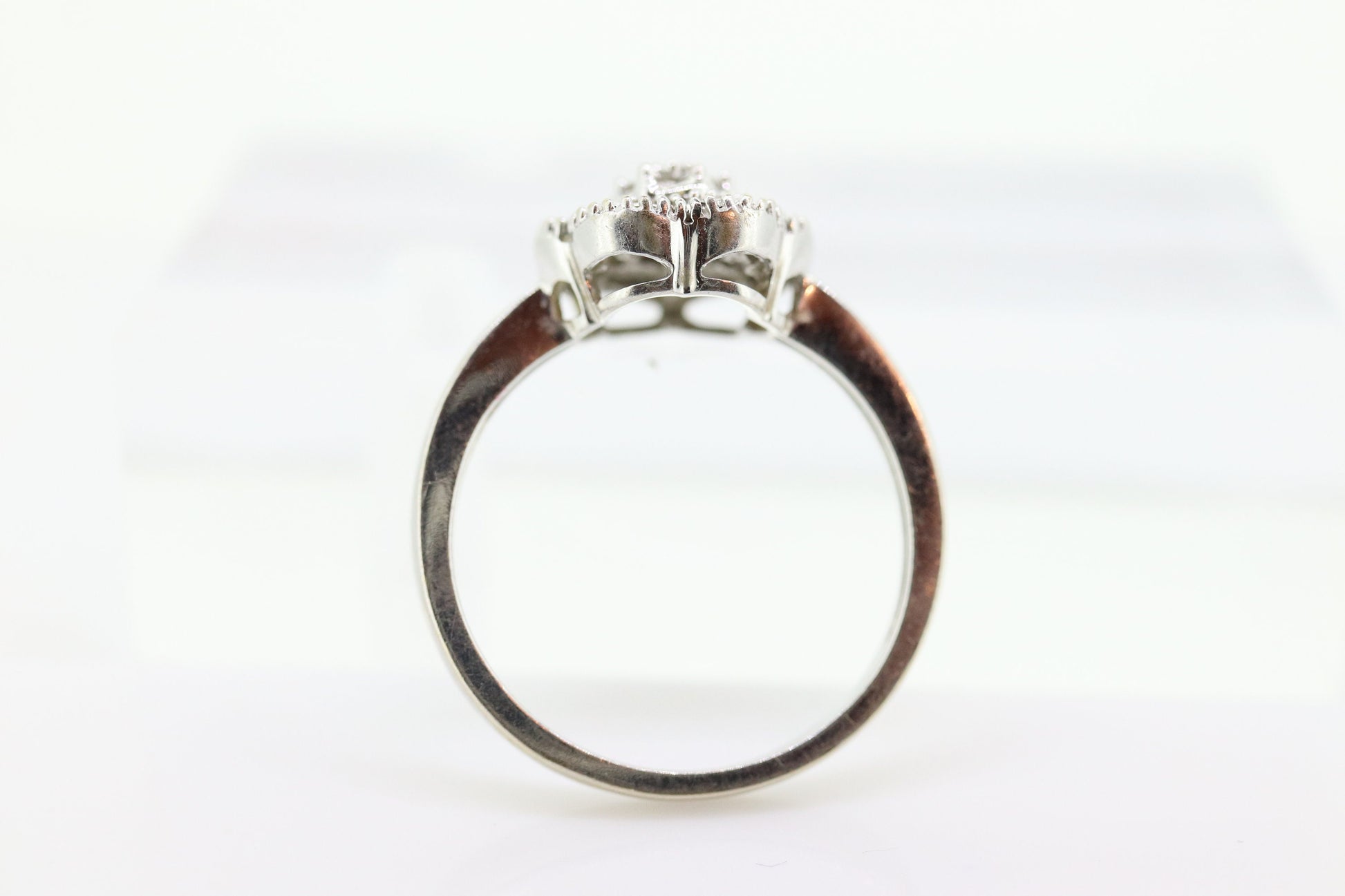 Diamond Daisy Cluster Elevated Ring. 10k White gold with round baguette diamond flower arrangement. st(52/90)