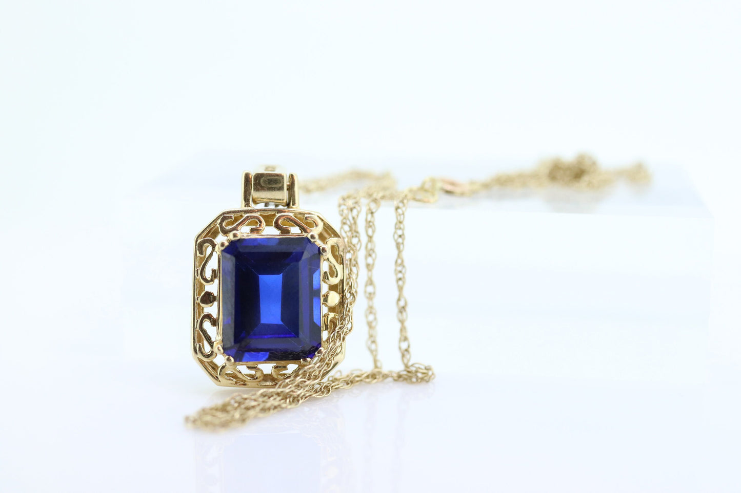 Blue emerald Sapphire and diamond 10k pendant. 10k twisted rope necklace