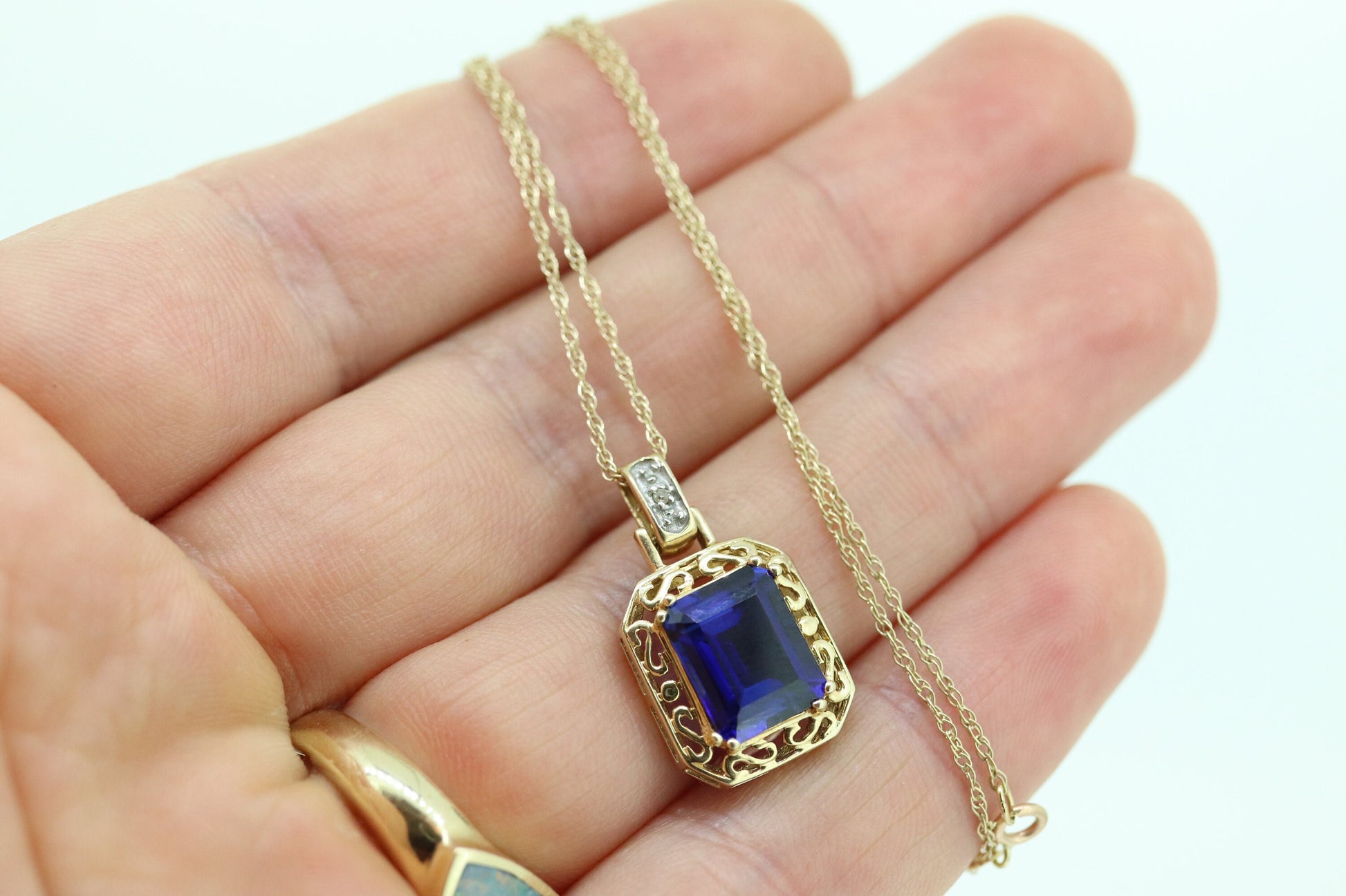 Blue emerald Sapphire and diamond 10k pendant. 10k twisted rope necklace