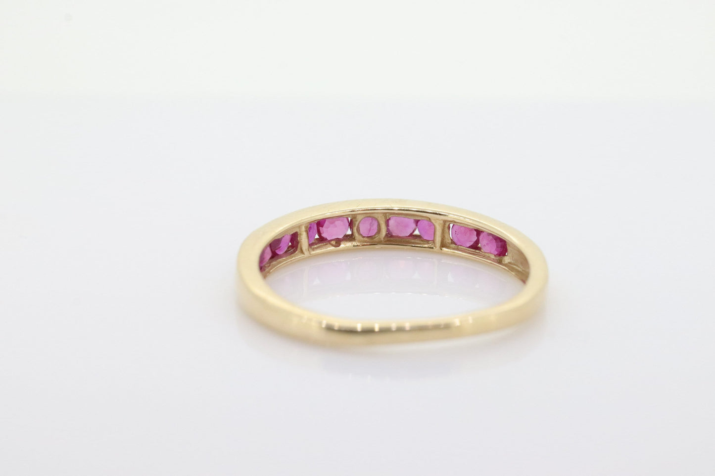 14k Eternity Half Ruby Ring. A 14k gold ring with round Ruby half eternity anniversary band. st(125)