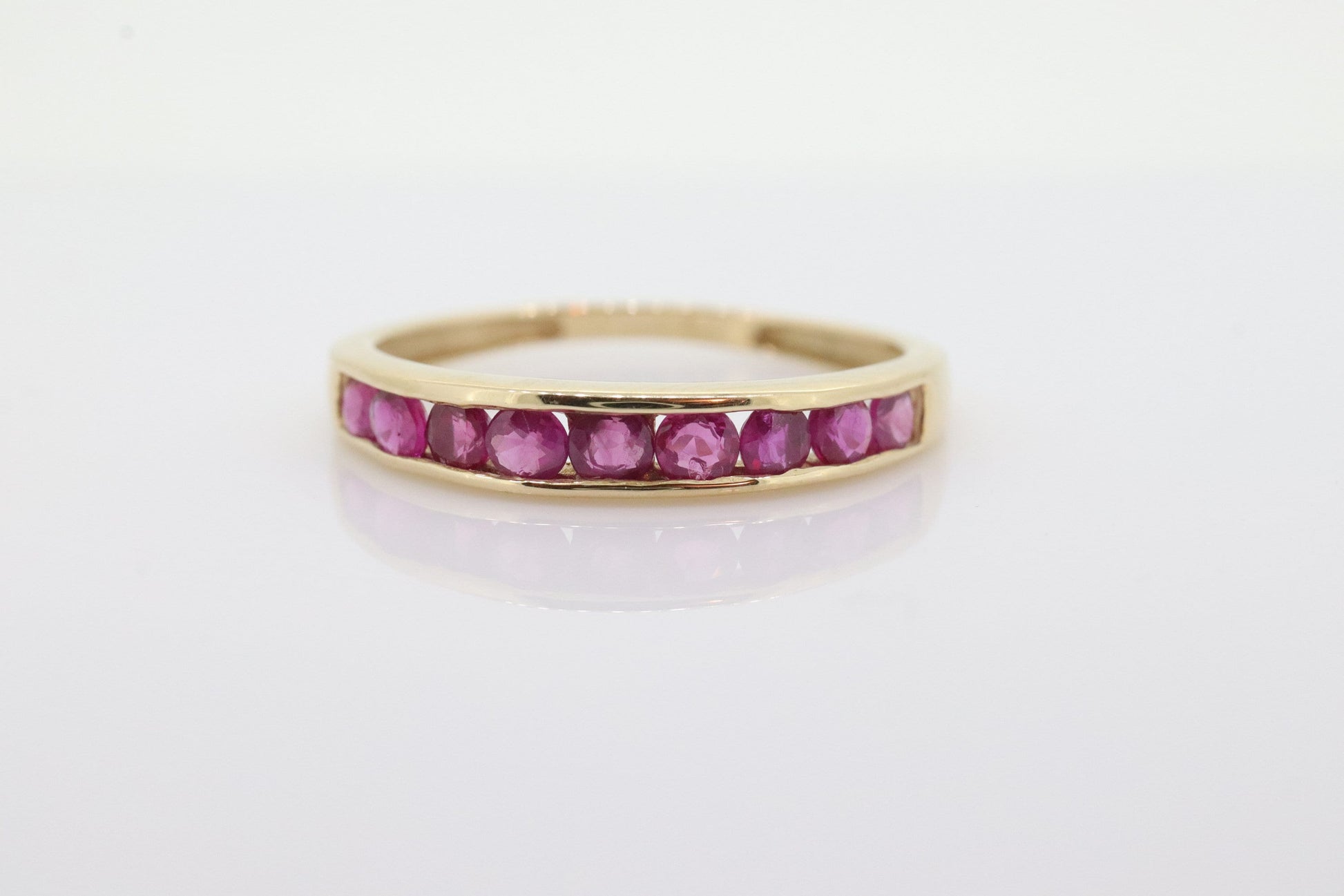 14k Eternity Half Ruby Ring. A 14k gold ring with round Ruby half eternity anniversary band. st(125)