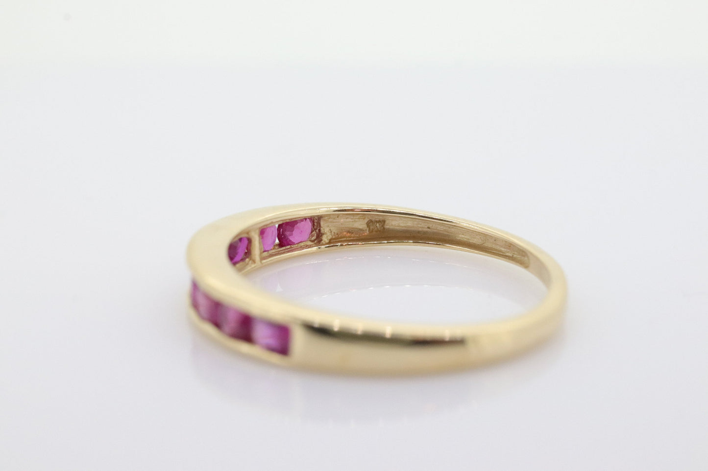 14k Eternity Half Ruby Ring. A 14k gold ring with round Ruby half eternity anniversary band. st(125)