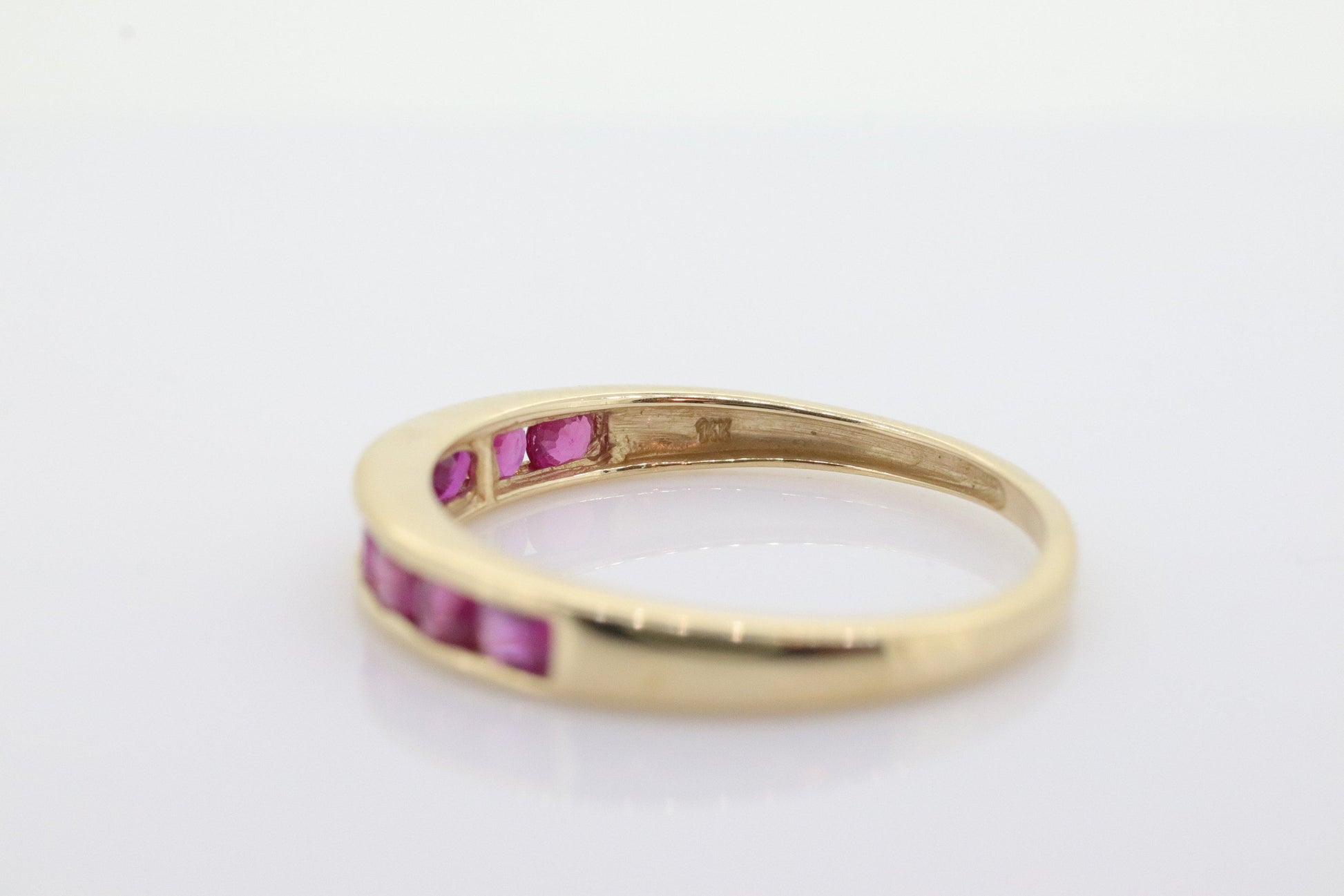 14k Eternity Half Ruby Ring. A 14k gold ring with round Ruby half eternity anniversary band. st(125)