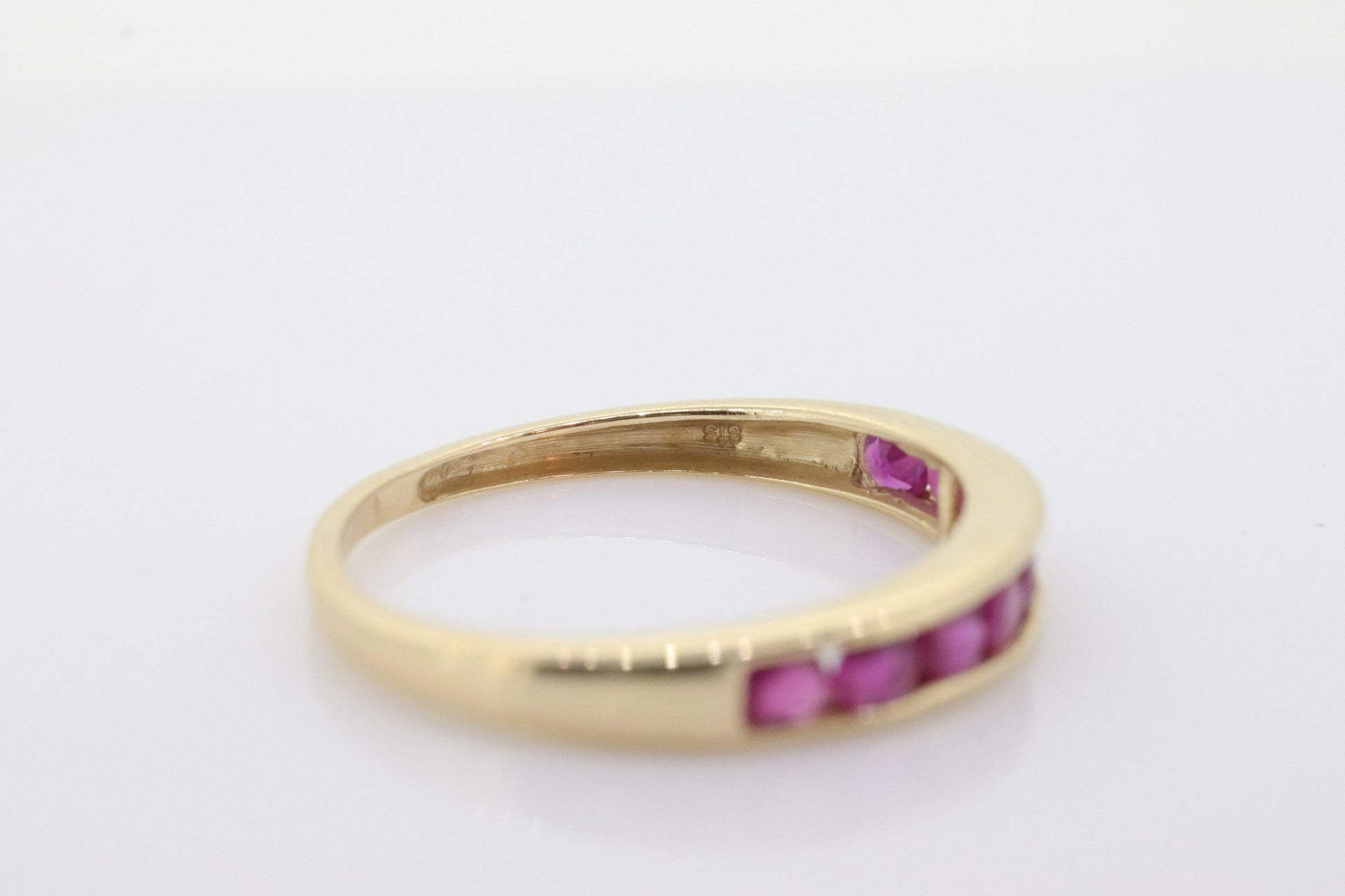 14k Eternity Half Ruby Ring. A 14k gold ring with round Ruby half eternity anniversary band. st(125)