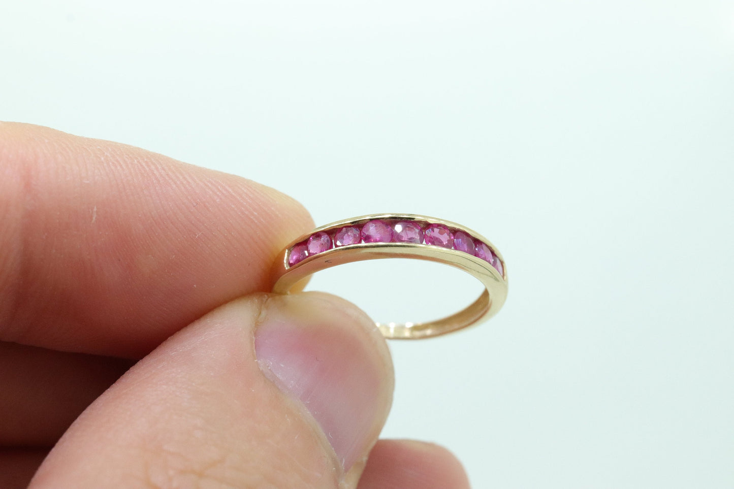 14k Eternity Half Ruby Ring. A 14k gold ring with round Ruby half eternity anniversary band. st(125)