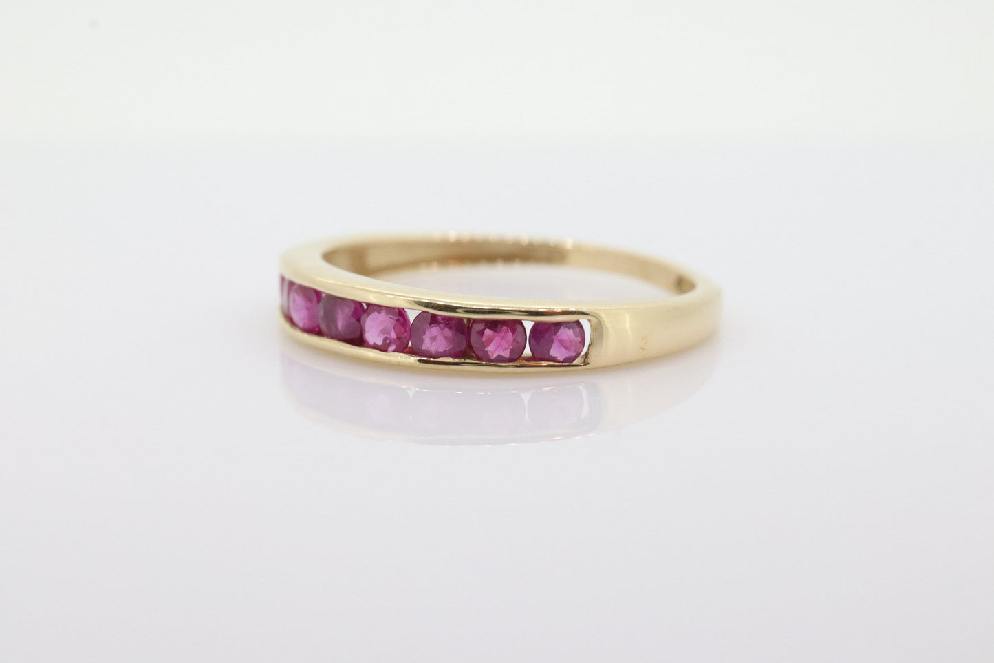 14k Eternity Half Ruby Ring. A 14k gold ring with round Ruby half eternity anniversary band. st(125)
