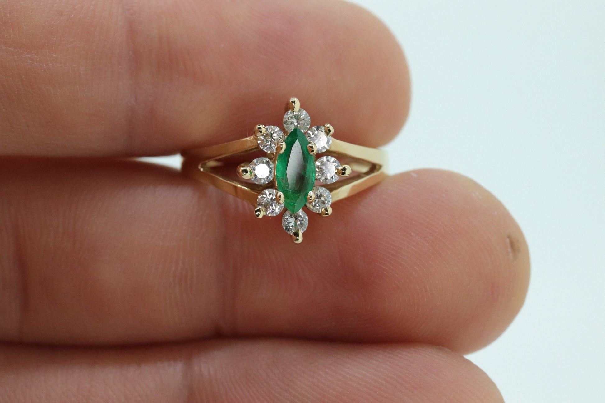14k Marquise Emerald and Diamond Halo yellow gold ring. 0.36ctw in diamonds