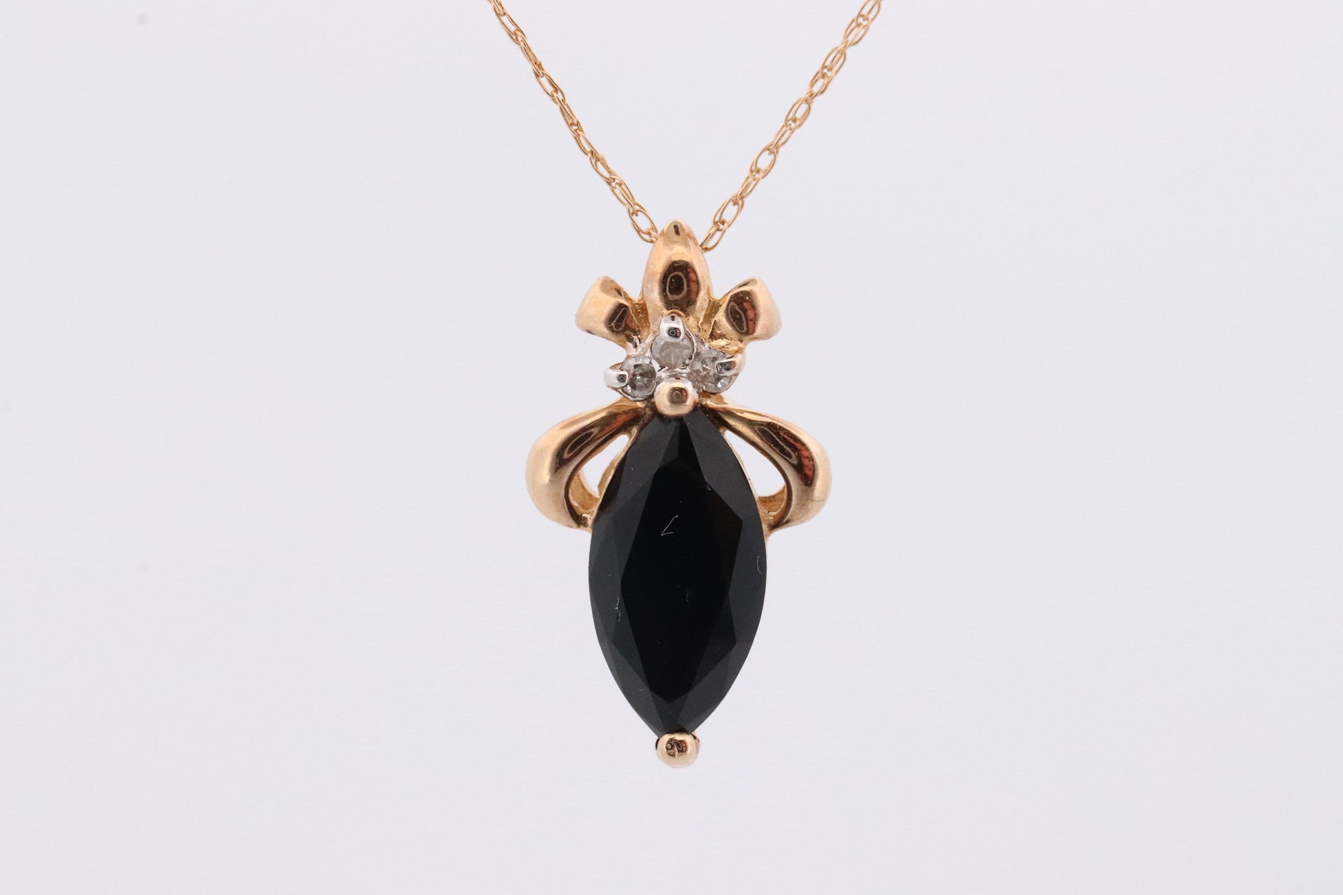 10k Onyx and Diamond Pendant. Marquise faceted Onyx and Diamond accent Pendant. Thin wheat chain necklace.