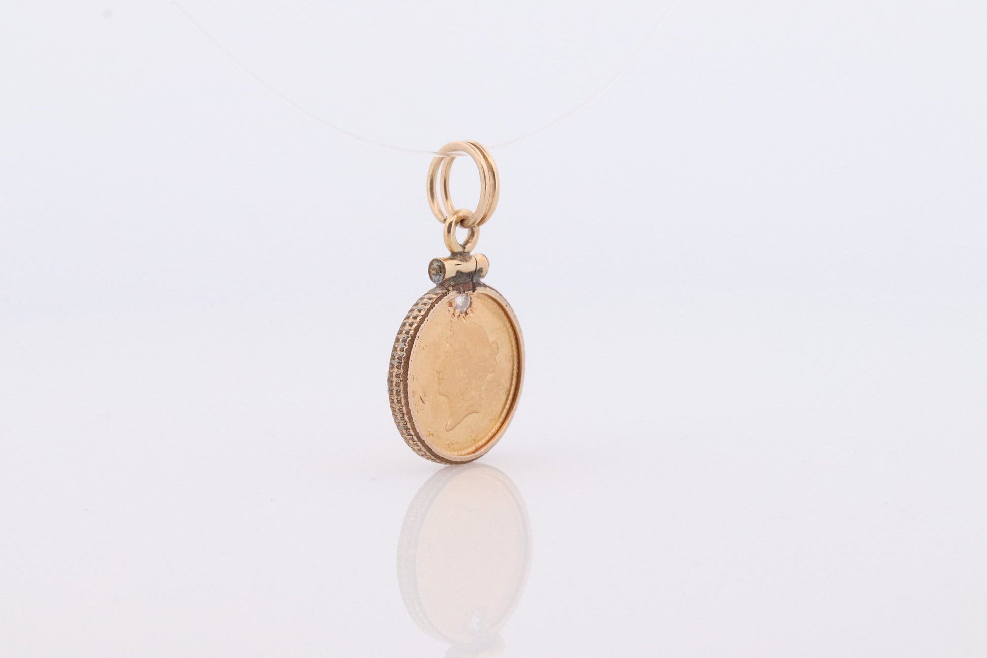 1849 US 1 dollar Liberty Head 900 gold 22K (21.6K) Gold coin set in a 14k yellow gold pendant or charm with a diamond.